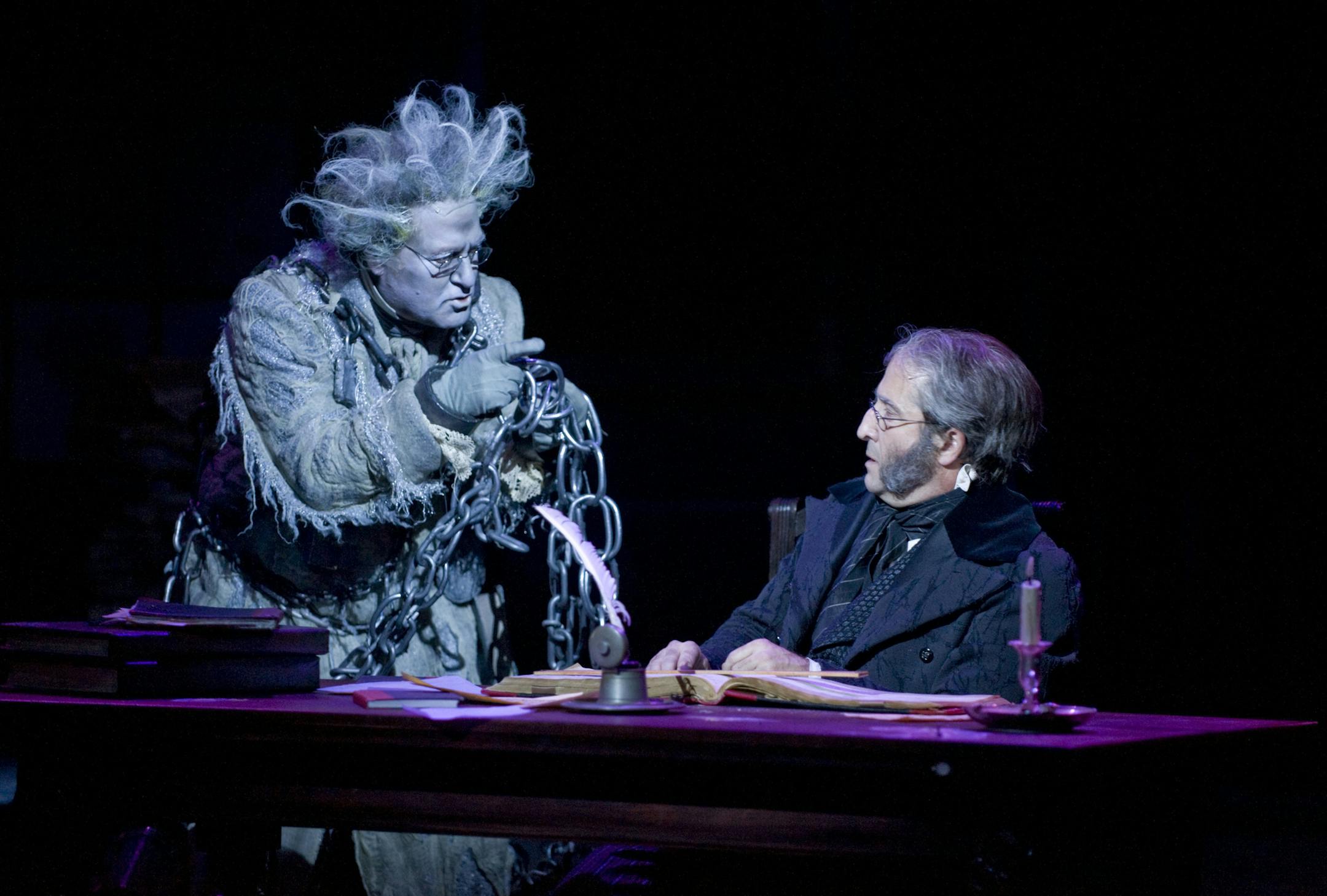 Bob Davis (Jacob Marley) and J.C. Cutler (Ebenezer Scrooge) in the Guthrie Theater's production of the Charles Dickens classic A Christmas Carol, adapted by Crispin Whittell and directed by Joe Chvala with set design by Walt Spangler, costume design by Mathew J. LeFebvre and lighting design by Christopher Akerlind. November 14 - December 29, 2013, on the Wurtele Thrust Stage at the Guthrie Theater, Minneapolis. Photo by Michael Brosilow