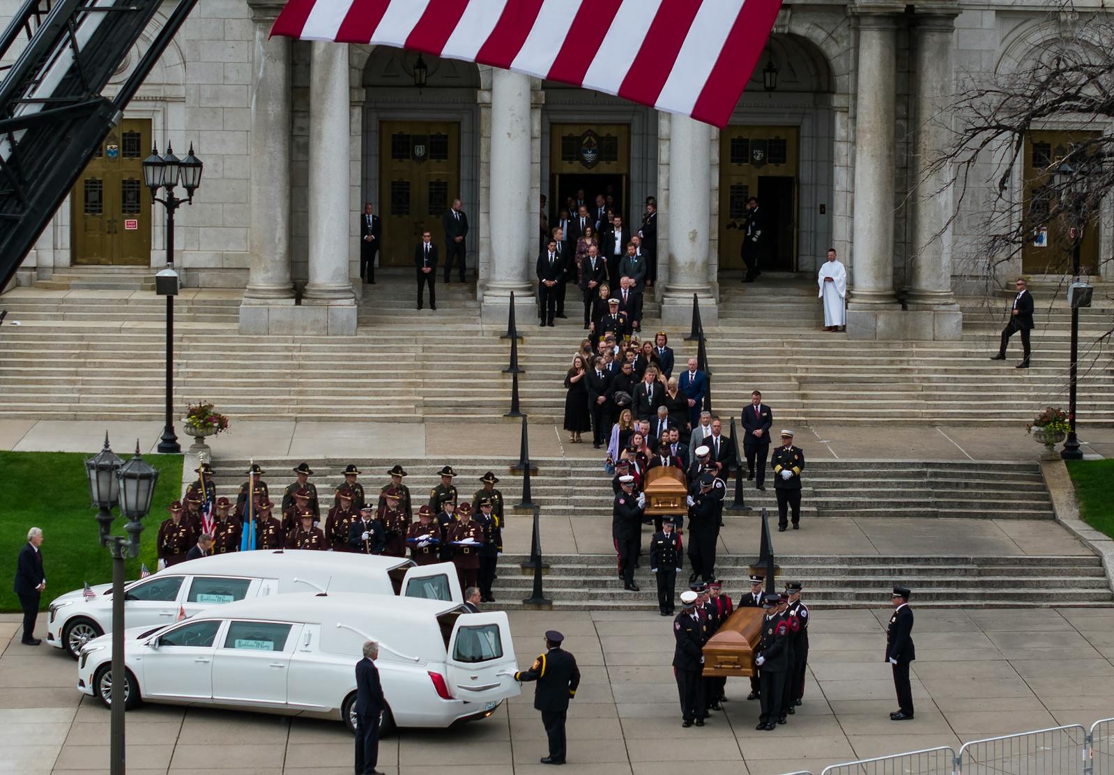 The caskets of Mark and Melissa Hortman leave the Basilica of St. Mary after funeral services in Minneapolis.