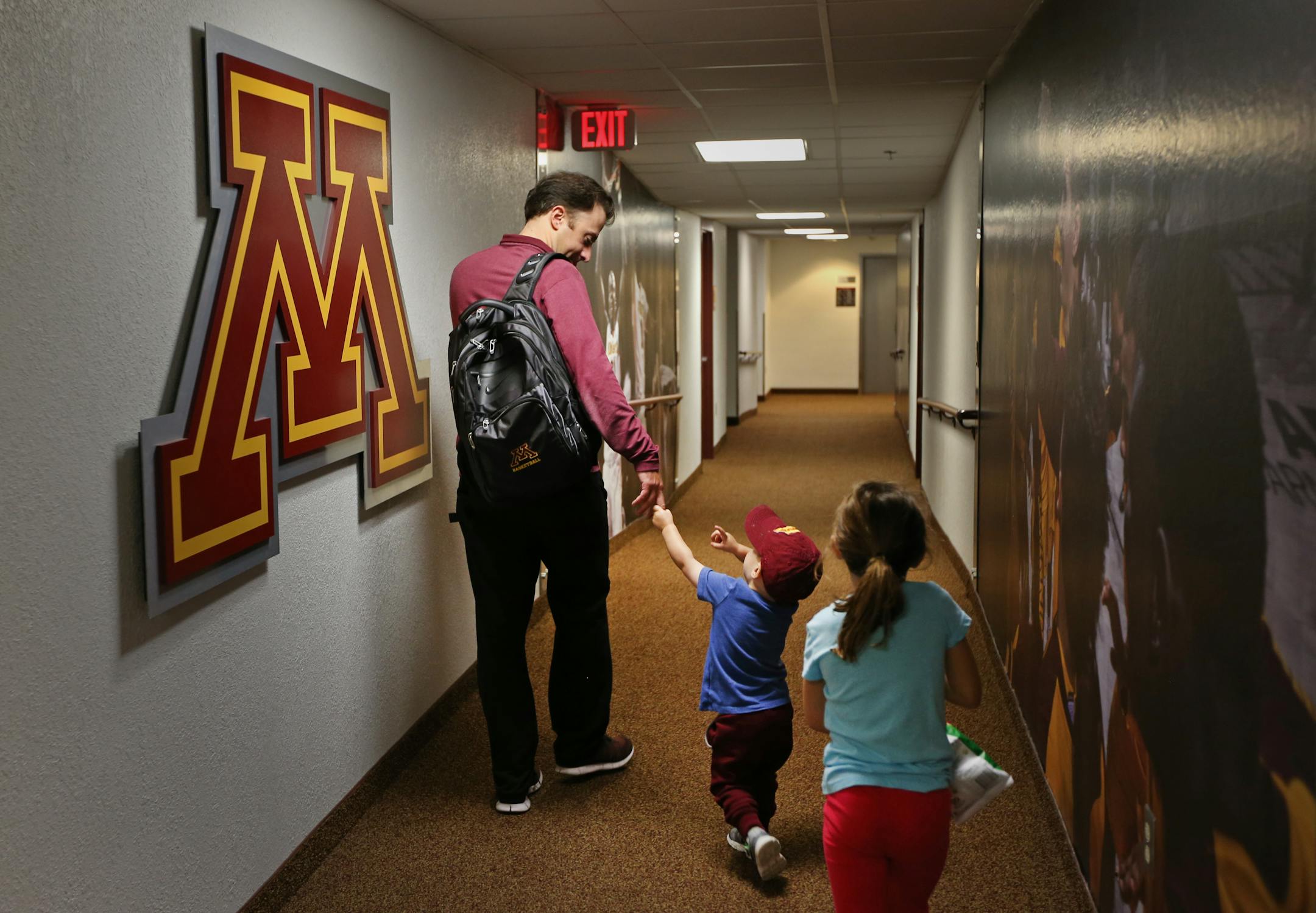 Richard Pitino walked with his two-year old son, Jack and daughter Ava underneath the court at Williams Arena before practice on October 15, 2016.