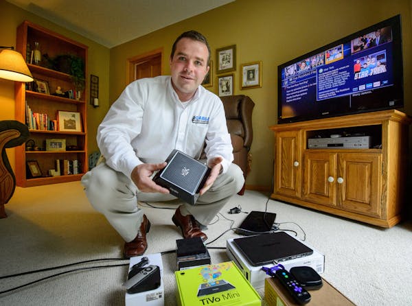 John Brillhart of Cable Alternatives shows some of the devices he discusses with clients. ] GLEN STUBBE * gstubbe@startribune.com Monday, May 11, 2015