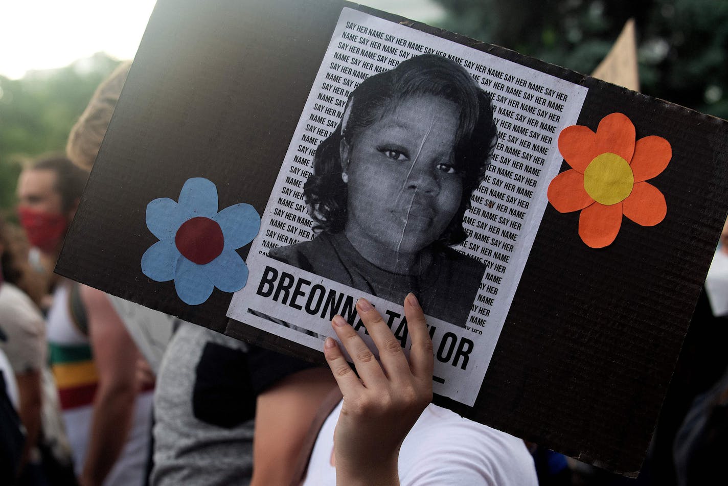 A demonstrator holds a sign with the image of Breonna Taylor, a black woman who was fatally shot by Louisville Metro Police Department officers, during a protest against police brutality, in Denver on June 3, 2020. (Jason Connolly/AFP/Getty Images/TNS) ORG XMIT: 1688231