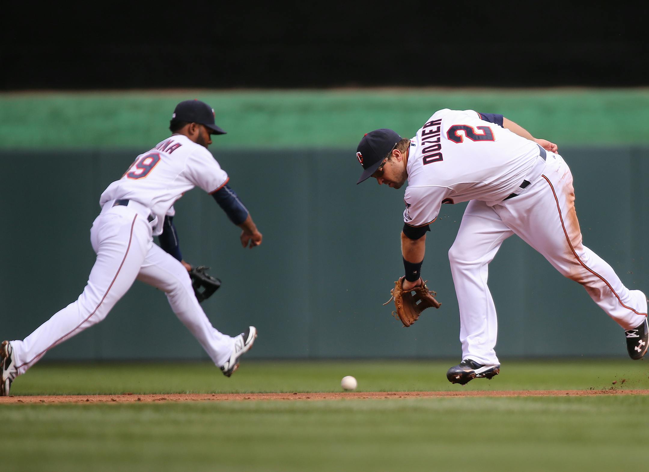 Brian Dozier, right, and Danny Santana miss a fielder during the Twins home opener against the Kansas City Royals at Target Field in Minneapolis on Monday, April 13, 2015. ] LEILA NAVIDI leila.navidi@startribune.com /