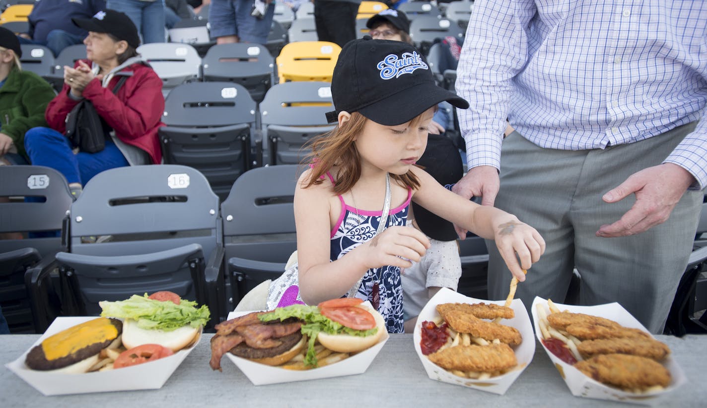 Lily Holen, 6, sampled a french fry during the St. Paul Saints home opener on Thursday night. ] Aaron Lavinsky &#x2022; aaron.lavinsky@startribune.com The St. Paul Saints hold their season opener against the Fargo-Moorhead Redhawks at brand-new CHS Field on Thursday, May 21, 2015.