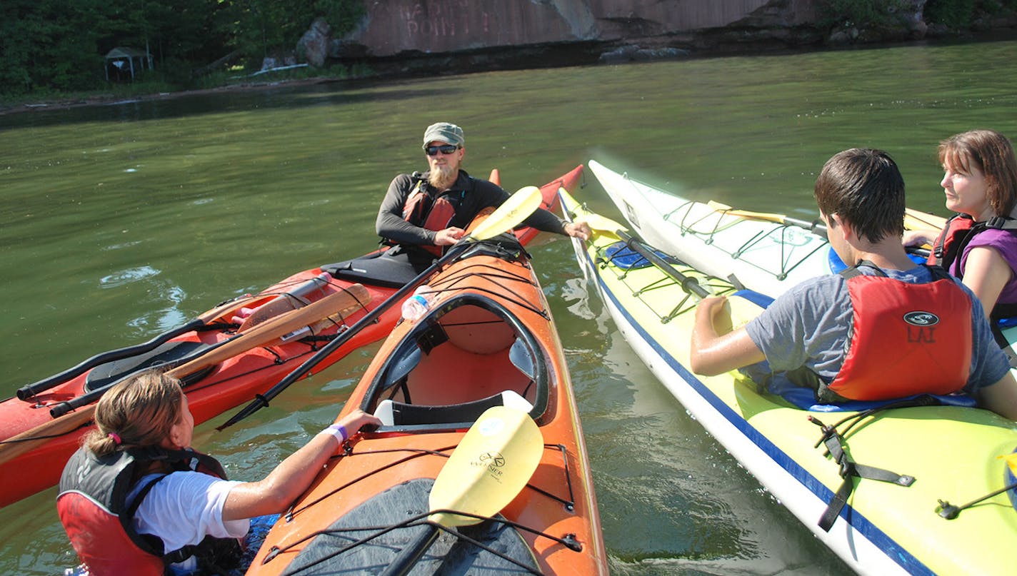 Bob Timmons robert.timmons@startribune.com Paige, a Living Adventures guide, steadied kayaks while paddlers cooled off last August in Lake Superior near the Bayfield Peninsula shoreline.