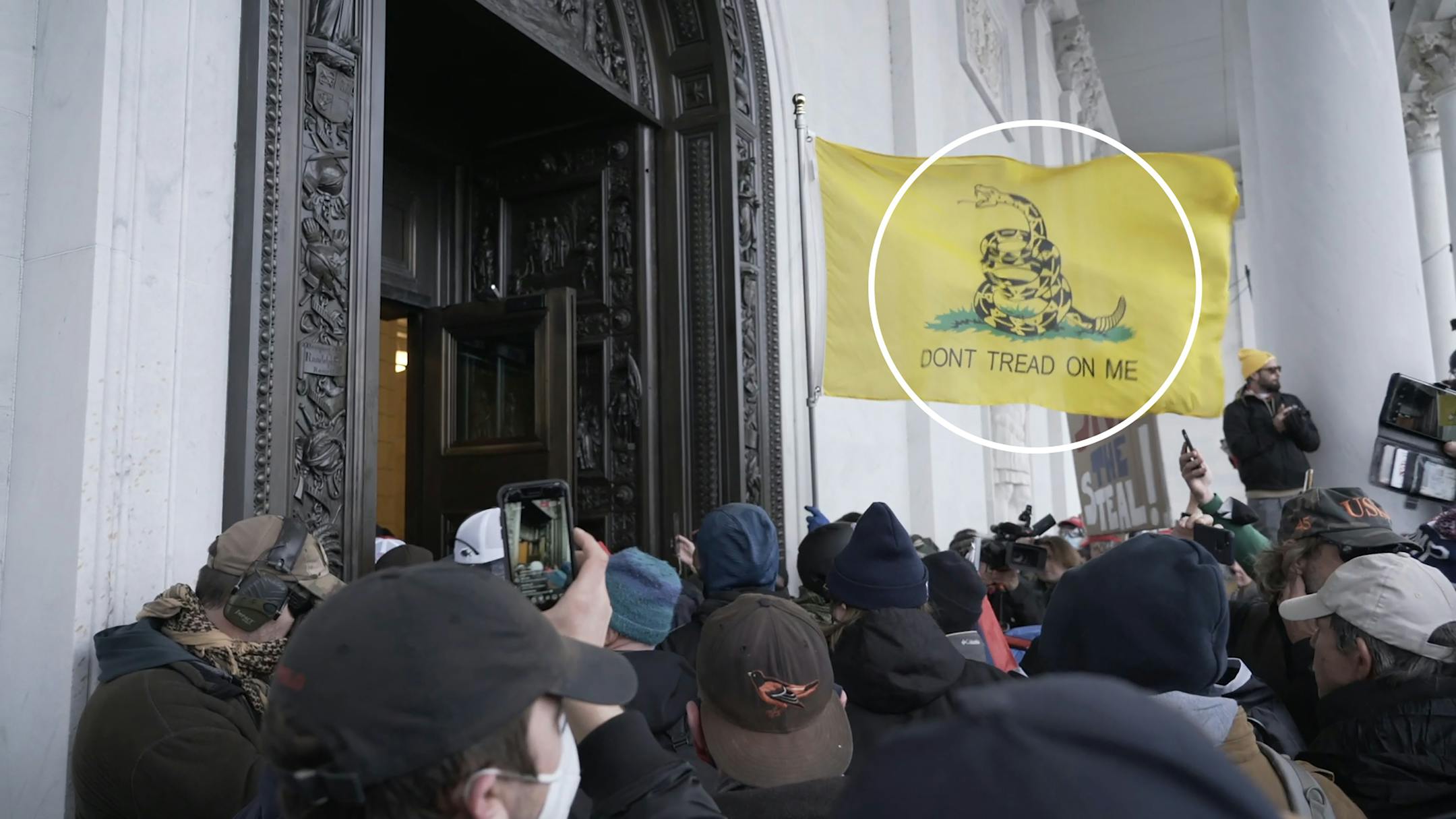 A still image from video shows a Gadsden flag as supporters of President Donald Trump storm the Capitol in Washington on Wednesday, Jan. 6, 2021.
