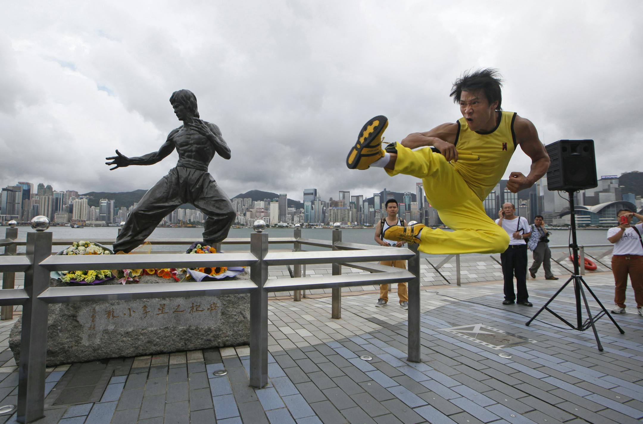 Chinese actor Mei Zhiyong dressing as the late Hong Kong Kung Fu star Bruce Lee performs in front of the bronze statue in Hong Kong Saturday, July 20, 2013 to commemorate the 40th anniversary of the death of Lee. The late superstar Bruce Lee is best-known for the kung fu skills he displayed in his movies, but his daughter hopes that more people take the effort to understand his teachings and life philosophy. Marking his death 40 years ago on July 20, the Hong Kong government has teamed up with t
