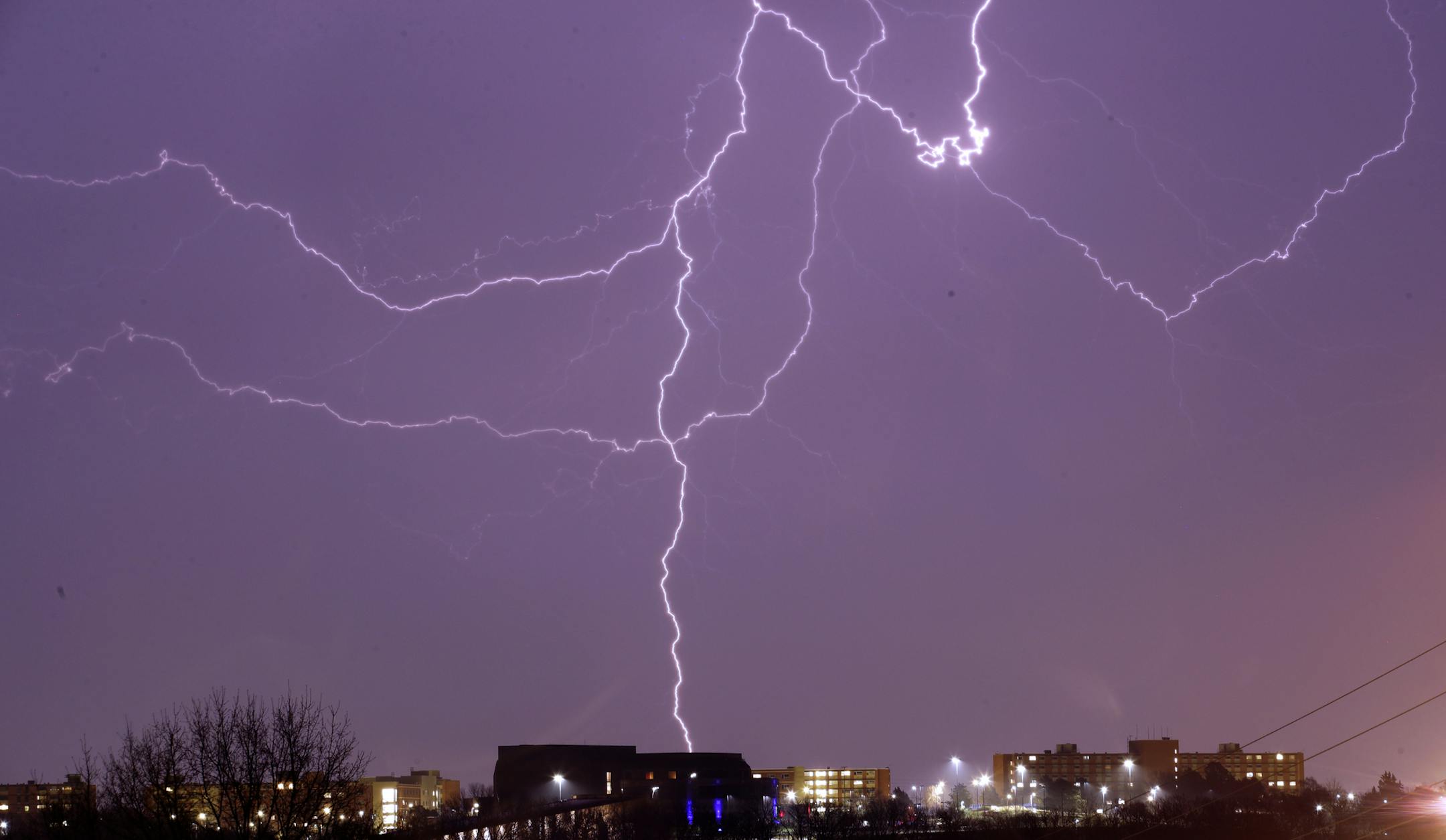 Lightning is seen in the sky over the University of Kansas in Lawrence, Kan., Thursday, March 26, 2020. Strong winds and hail are forecast for the area. (AP Photo/Orlin Wagner)