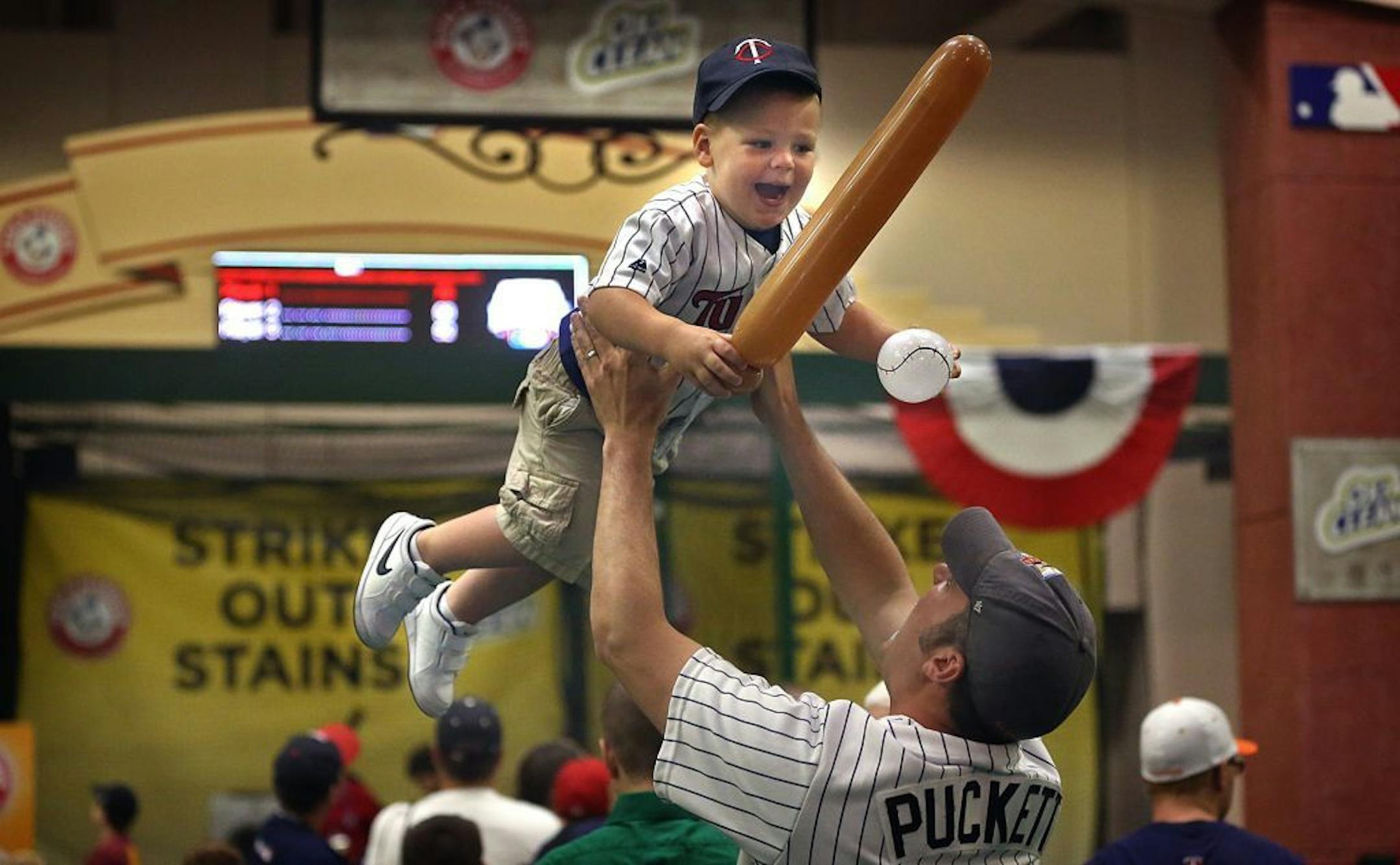 Josh Jansen, Minnetonka, playfully lifted his son, Beckett, 2, in the air as the two enjoyed the sights and activities at FanFest.