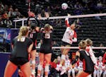 Benilde-St. Margaret's Sierre Lumpkin (24) went up on the attack in the fifth set of the Red Knights' 3-2 victory at the Xcel Energy Center on Wednesd