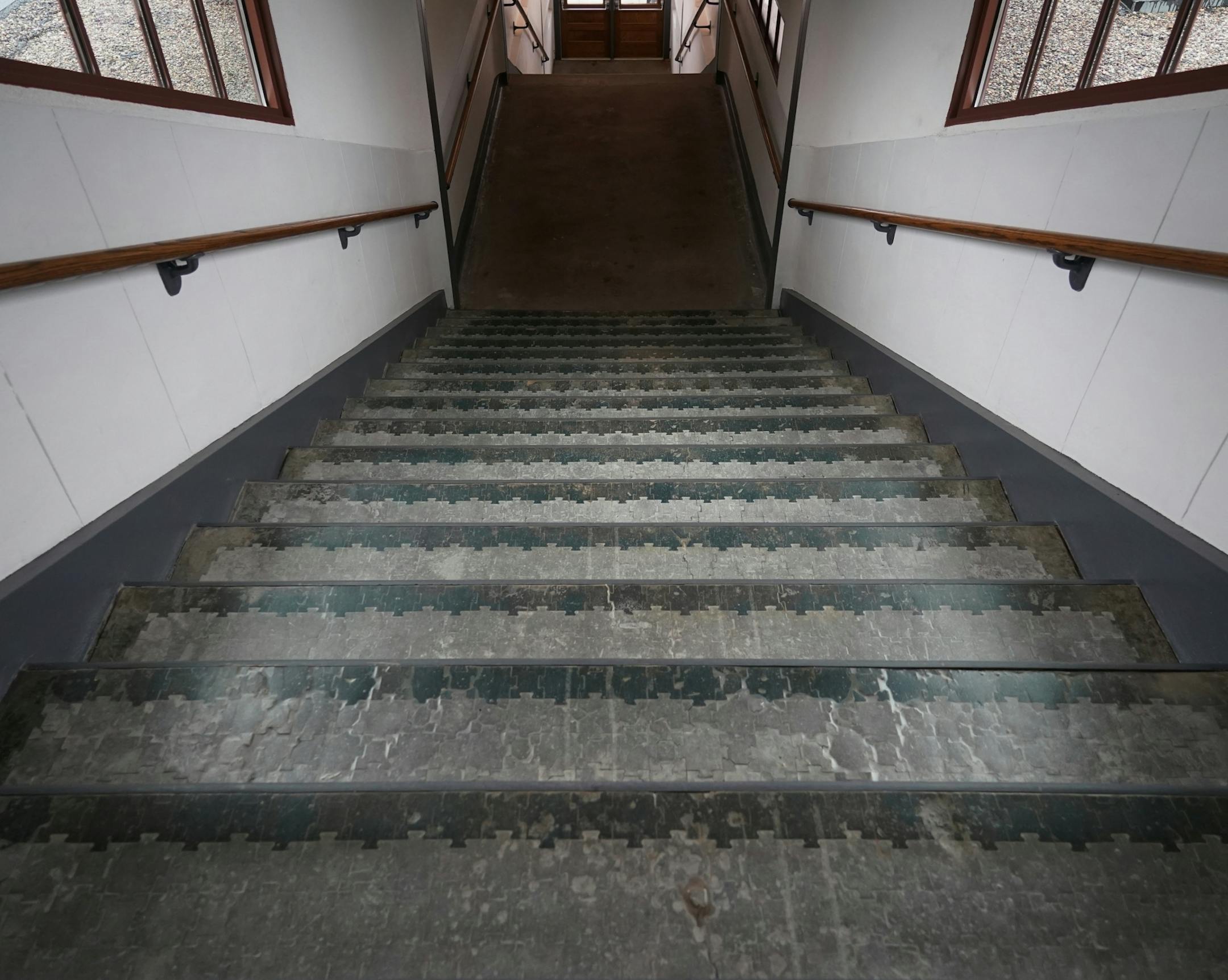As part of the Union Station restoration project, the one remaining original staircase which served tracks 1 and 2 was moved in whole from where it originally stood near Kellogg Boulevard to Gate B. The steps are tiled with unique puzzle-shaped pieces.