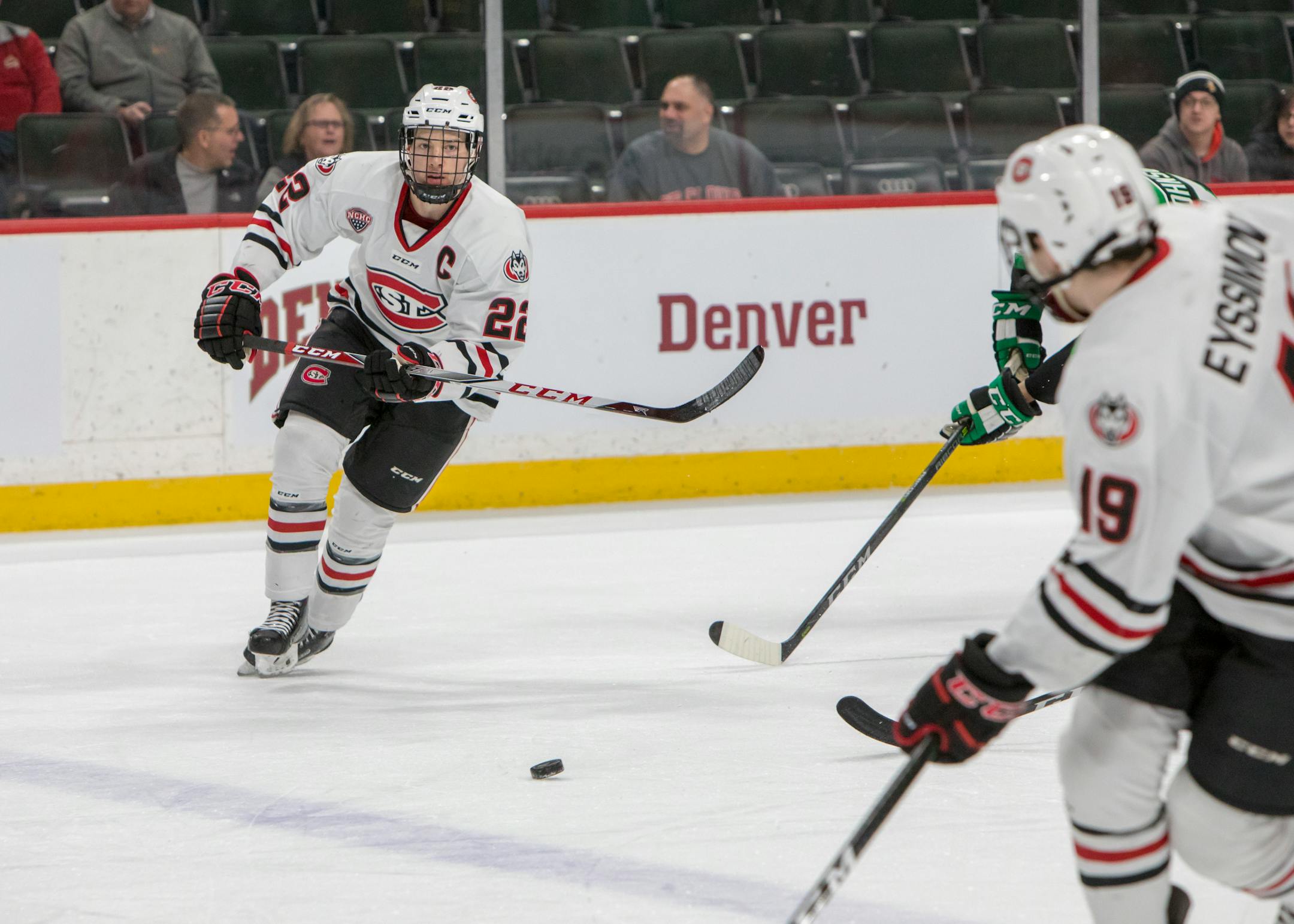 St. Cloud State Huskies defenseman Jimmy Schuldt (22) passes to forward Mikey Eyssimont (19) in game one of the NCHC Frozen Faceoff. [ Special to Star Tribune, photo by Matt Blewett, Matte B Photography, matt@mattebphoto.com, St. Cloud State Huskies, University of North Dakota, NCHC Frozen Faceoff, Xcel Energy Center, March 16, 2018, Minnesota, SAXO 1005722774 NCHC031718