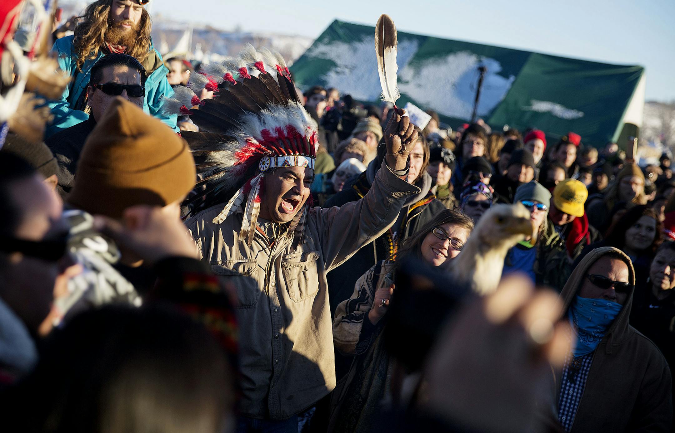 A crowd gathers in celebration at the Oceti Sakowin camp after it was announced that the U.S. Army Corps of Engineers won't grant easement for the Dakota Access oil pipeline in Cannon Ball, N.D., Sunday, Dec. 4, 2016. (AP Photo/David Goldman) ORG XMIT: NDDG117