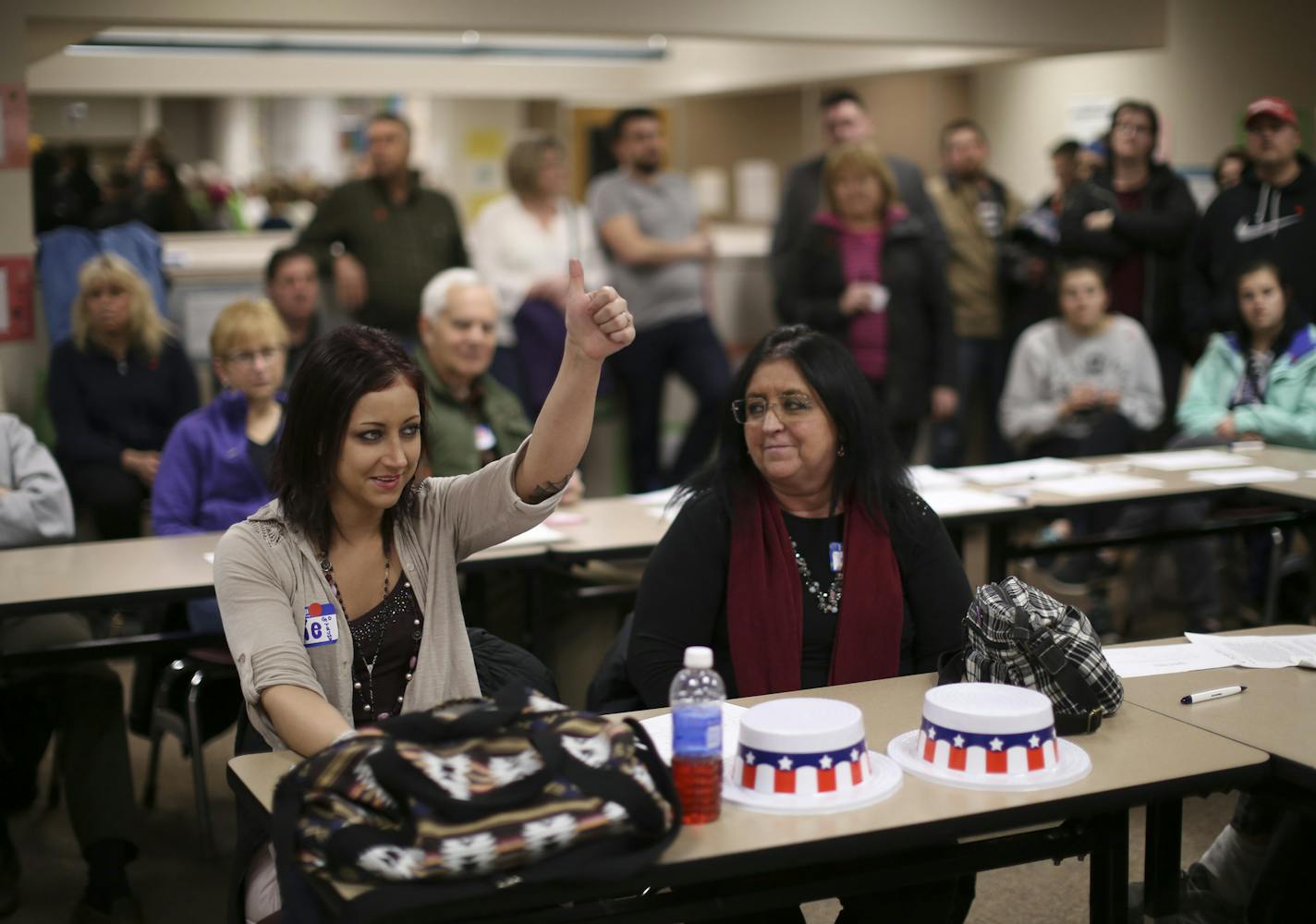 Alexandra Herkal, 27, gave a thumbs up as she spoke in support of Donald Trump at the Burnsville precinct 9 Republican caucus Tuesday night. A first time caucus attendee, she brought her mother, Michelle, right. ] JEFF WHEELER &#xef; jeff.wheeler@startribune.com Eagan and Burnsville residents gathered to attend their precinct caucuses at Black Hawk Middle School Tuesday evening, March 1, 2016.