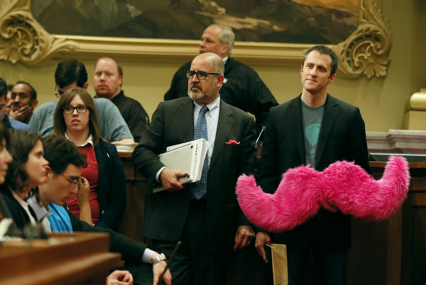 Matthew Johnson, right, waited to speak at a public hearing on Tuesday as supporters of app-based transportation companies also spoke at City Hall.