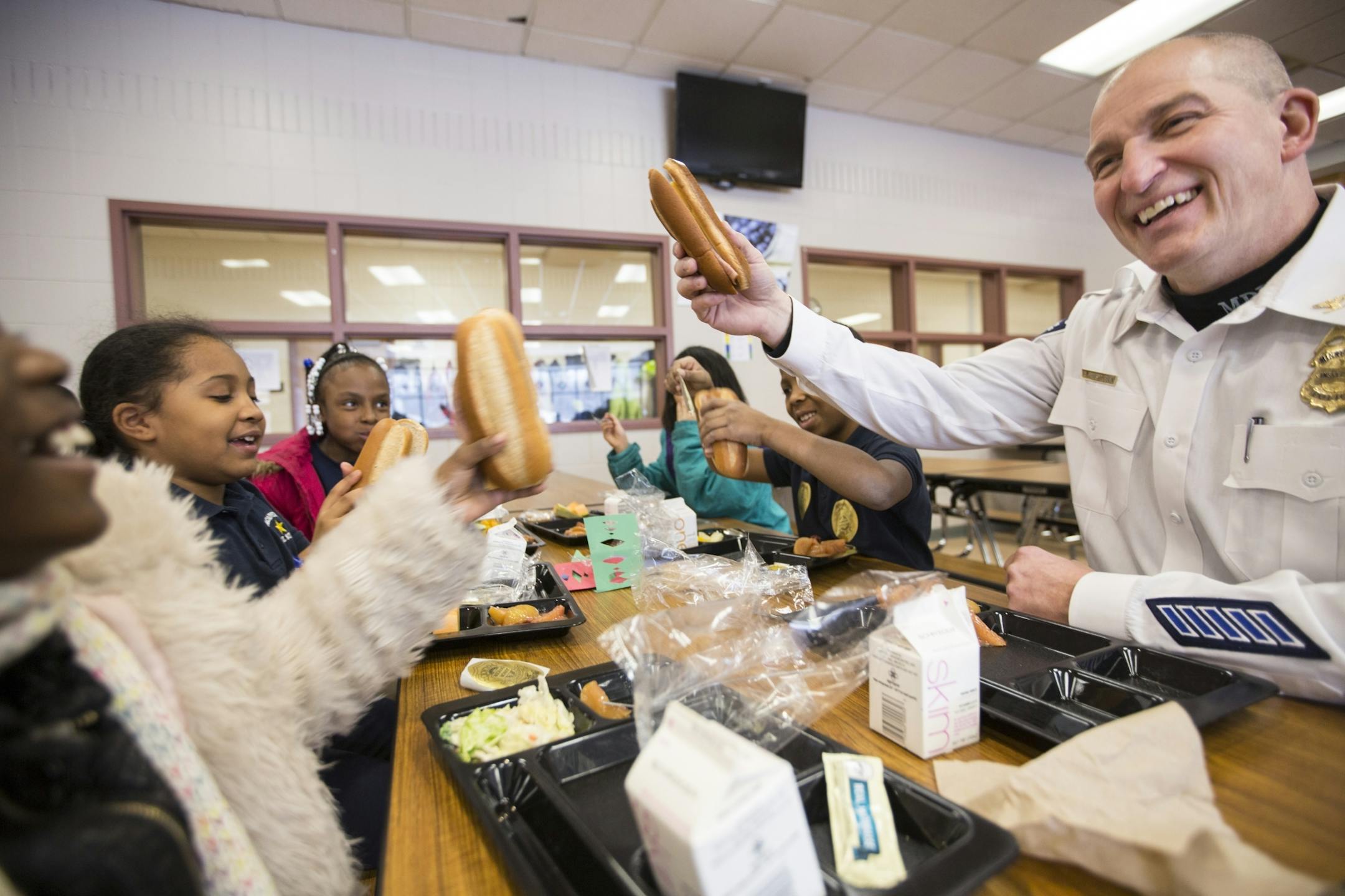 Inspector Mike Friestleben of the Minneapolis Police Department's Fourth Precinct has lunch with third graders at Lucy Craft Laney Community School in Minneapolis for lunch on Thursday, February 4, 2016.