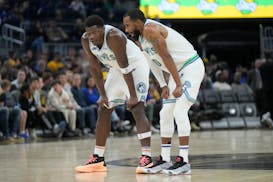 Minnesota Timberwolves guards Anthony Edwards, left, and Mike Conley during an NBA basketball game against the Golden State Warriors in San Francisco,