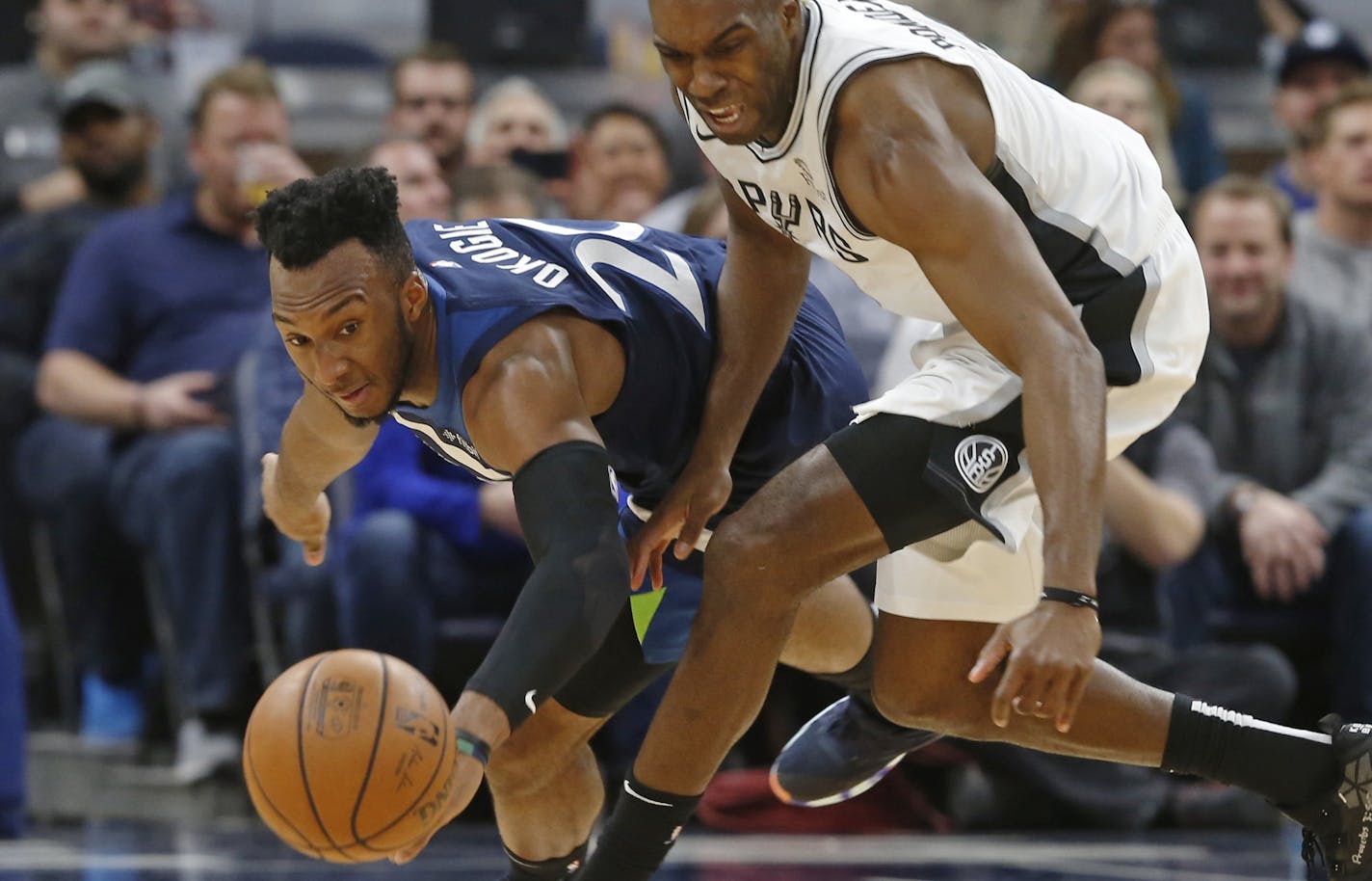 Minnesota Timberwolves' Josh Okogie, left, of Nigeria, and San Antonio Spurs' Quincy Pondexter chase the loose ball in the second half of an NBA basketball game Wednesday, Nov. 28, 2018, in Minneapolis. The Timberwolves won 128-89. (AP Photo/Jim Mone) ORG XMIT: MIN2018112906420402