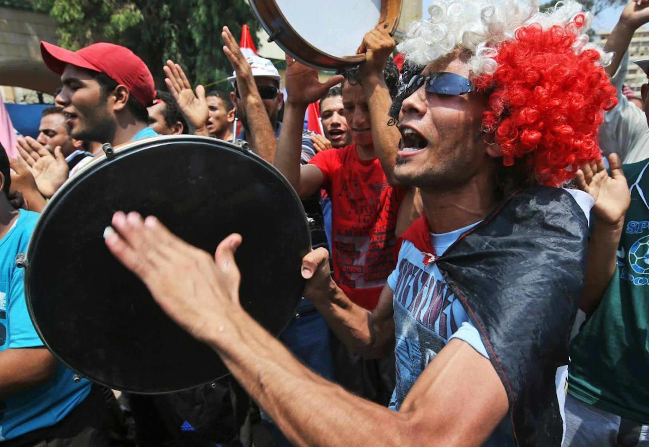Supporters of Egypt's ousted President Mohammed Morsi beats their drums as they shout slogans during a demonstration in Nasr city, Cairo, Egypt, Friday, July 19, 2013.