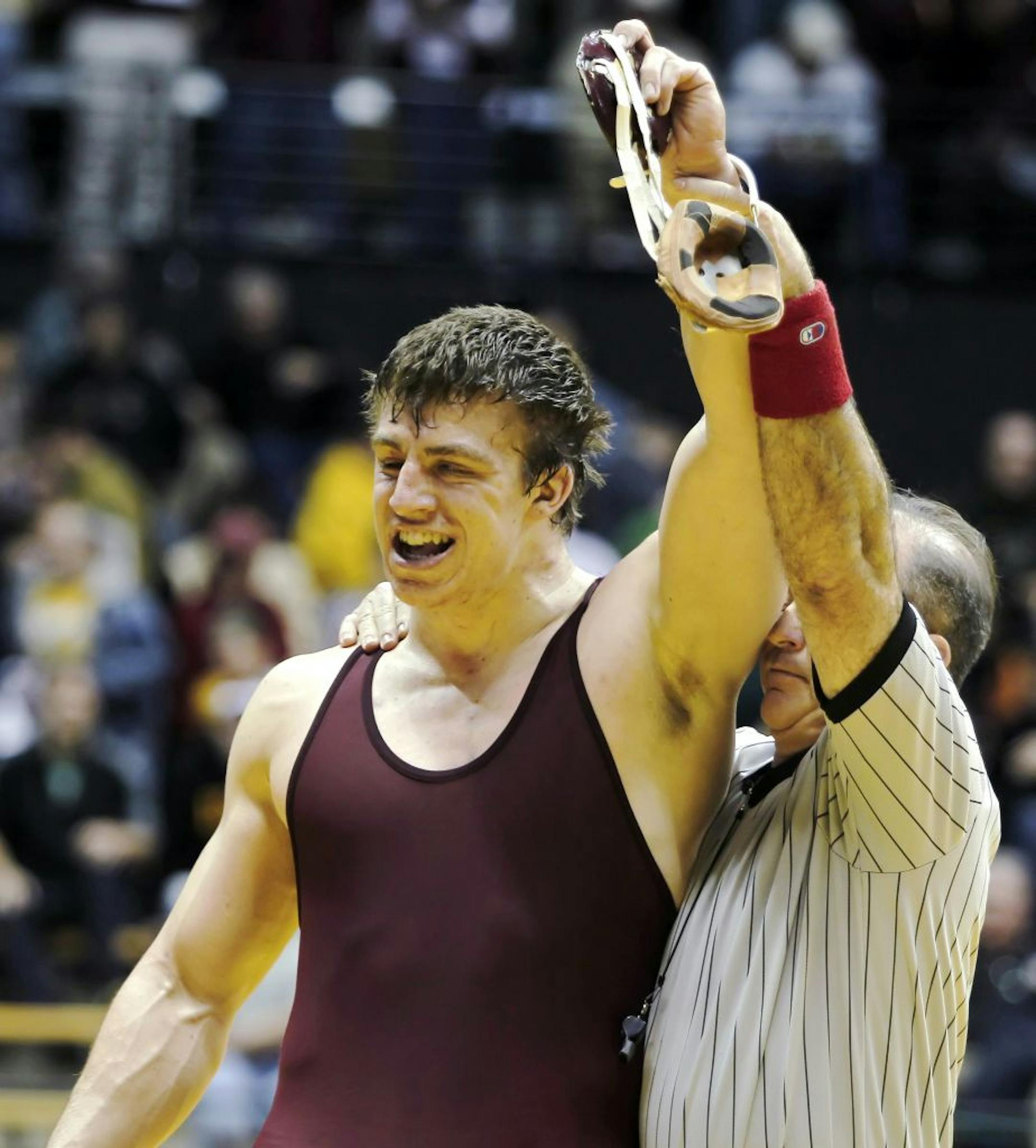 Minnesota's Tony Nelson celebrates his win over Iowa's Bobby Telford after their 285-pound match at the Big Ten wrestling championship, Sunday.