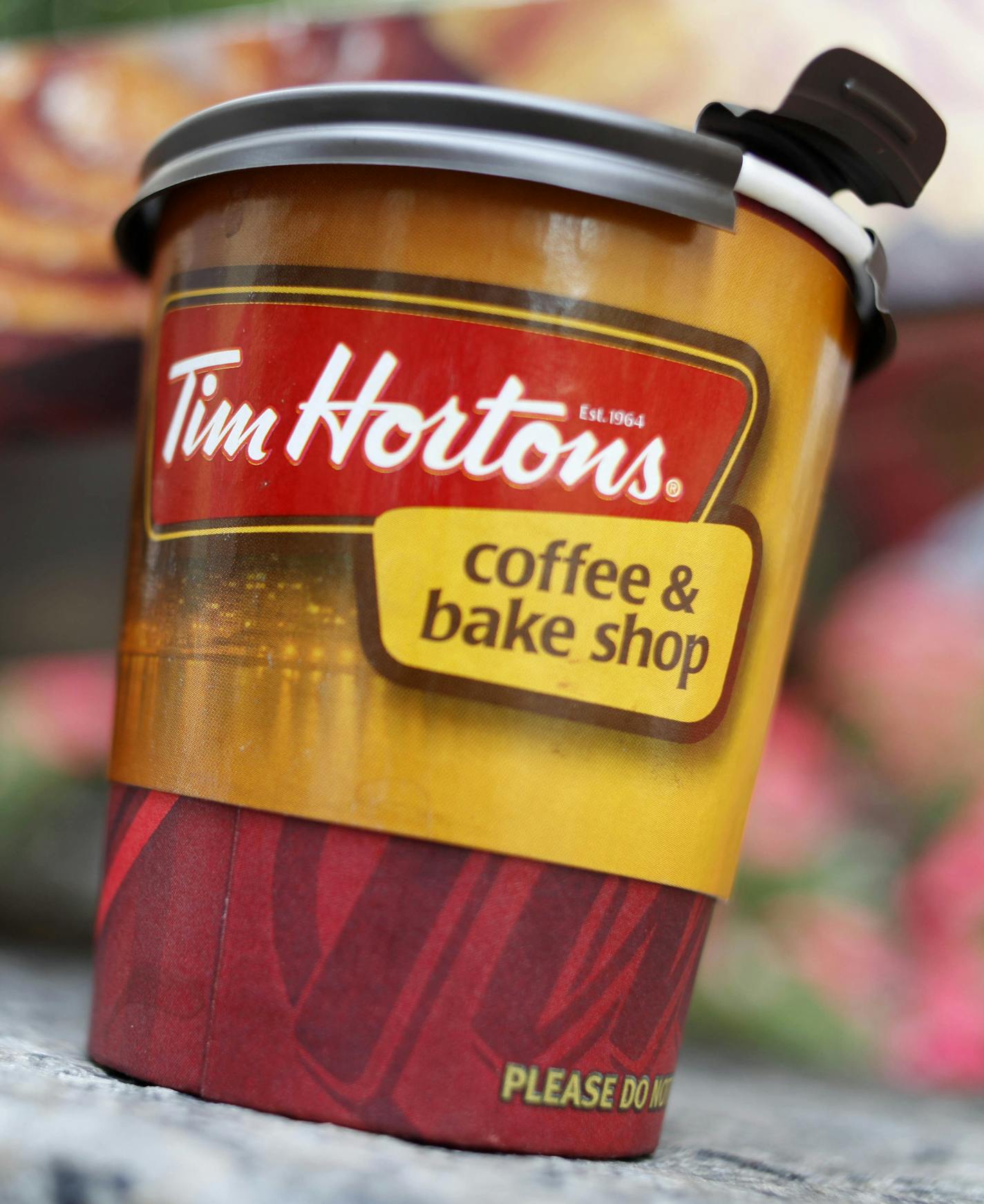 A Tim Hortons' coffee cup is seen in New York, Wednesday, July 22, 2009. The Canadian doughnut chain moved into 12 former Dunkin Donut locations earlier in the month, bringing new blood to the doughnut war in America's most competitive market. (AP Photo/Seth Wenig)