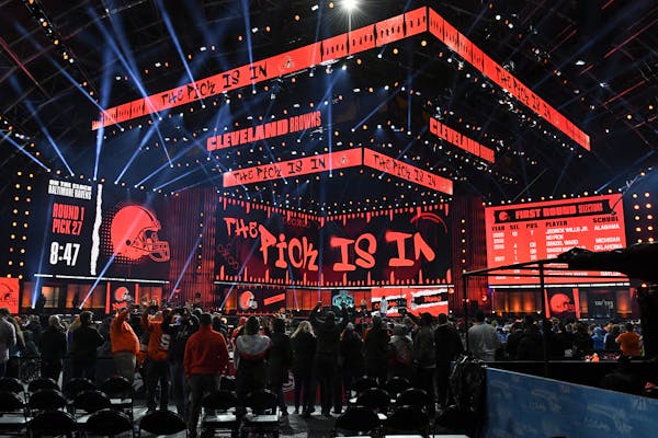 Fans gather around the stage as they wait for the Cleveland Browns to make their first-round pick in the NFL football draft Thursday April 29, 2021, i