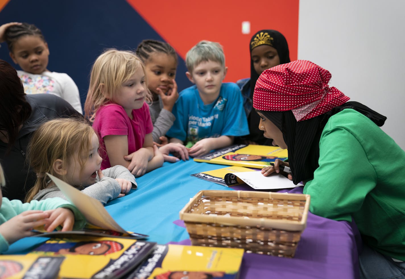 A group of children surrounded Habso Mohamud, 24, a St. Cloud author who wrote a children's book to inspire kids to make a difference in the world, as she signed books with personal messages encouraging them to do achieve their specific goals after a reading at the Children's Museum in St. Paul, Minn., on Monday, January 21, 2019. The children from the left are Elsie Inman, 4, Moriah Brooks, 7, Finley Hooper, 6, Malia Brooks, 5, Hunter Hooper, 8, and her little sister Zubayda Mohamed, 6. ] RENEE