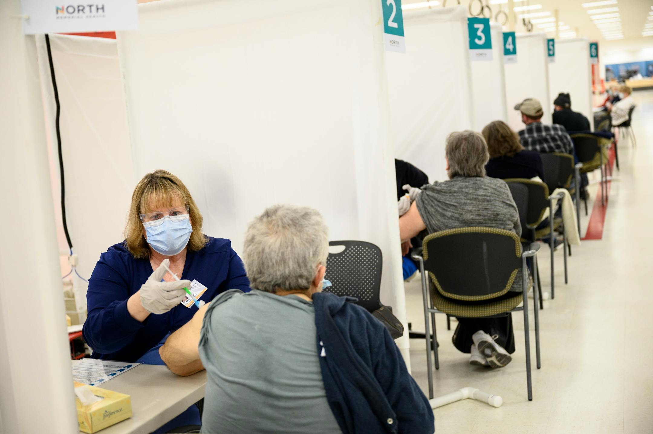 Blue Cross and Blue Shield of Minnesota nurse Debra Kloyda administered a dose of the Moderna COVID-19 vaccine to an elderly woman at North Memorial Health Hospital's vaccination clinic in Brooklyn Center