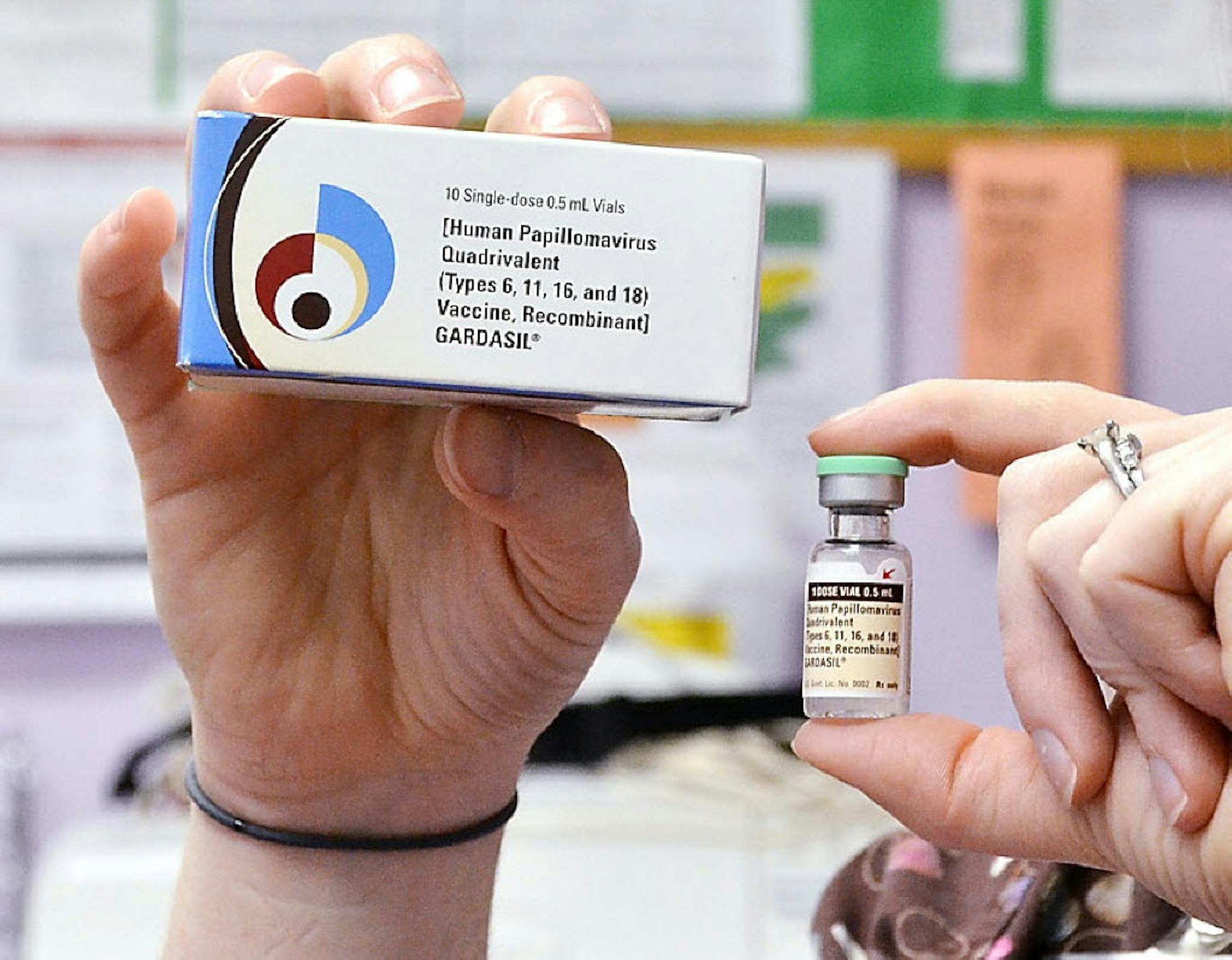 A nurse holds up a vial and box for the HPV vaccine, brand name Gardasil, at a clinic in Kinston, N.C.