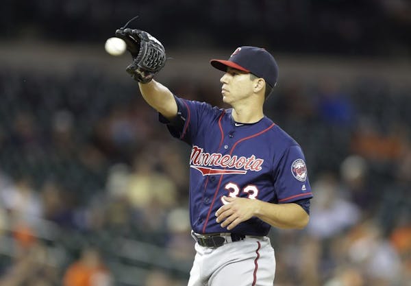 Minnesota Twins starting pitcher Tommy Milone waits on a new ball during the ninth inning of a baseball game against the Detroit Tigers, Tuesday, July