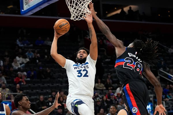 Timberwolves center Karl-Anthony Towns (27 points) drove on Pistons center Isaiah Stewart on Wednesday night. The Wolves prevailed 124-117 over NBA-wo