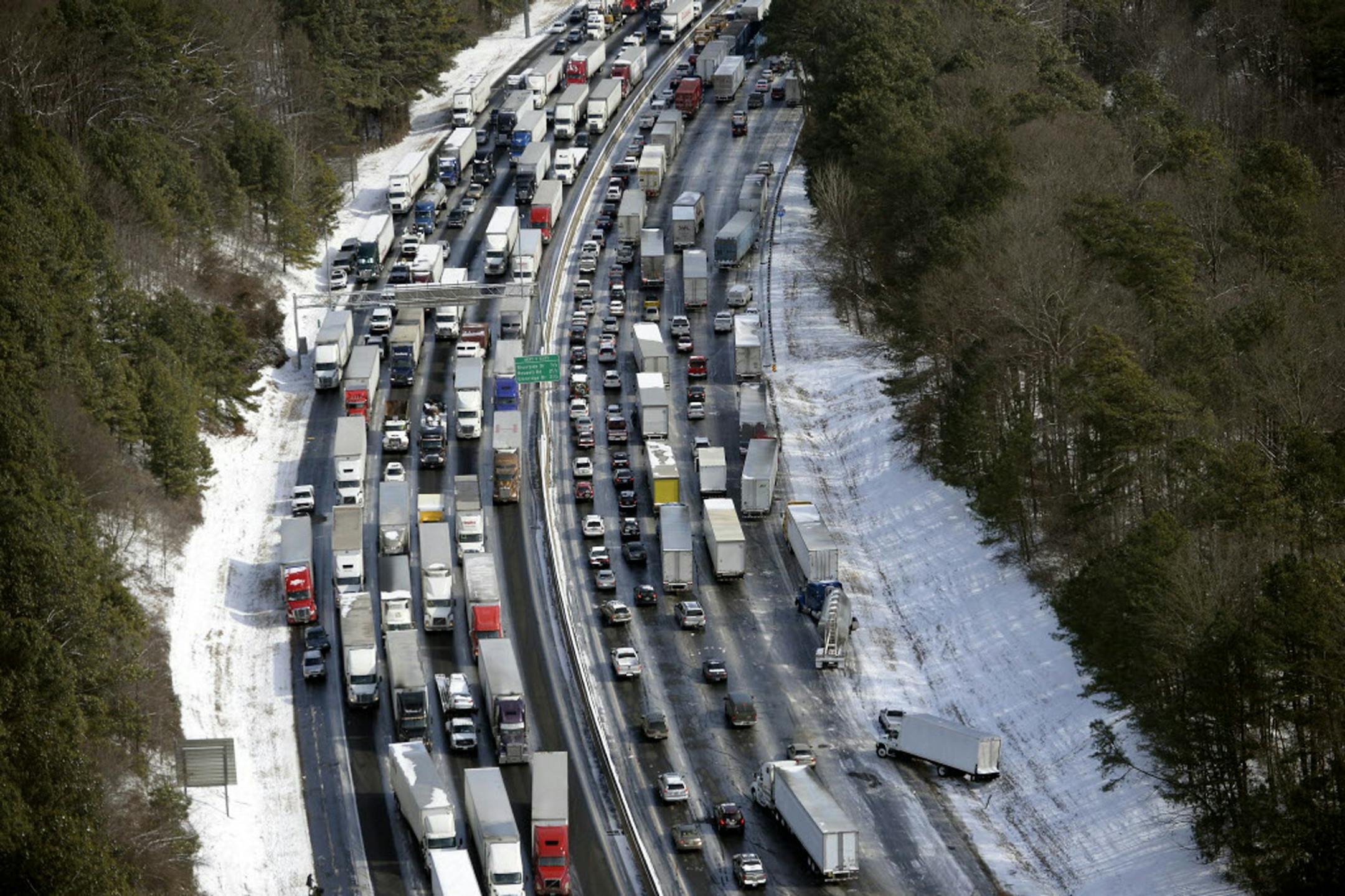 In this aerial photo, traffic is snarled along the I-285 perimeter north of the metro area after a winter snow storm, Wednesday, Jan. 29, 2014, in Atlanta.