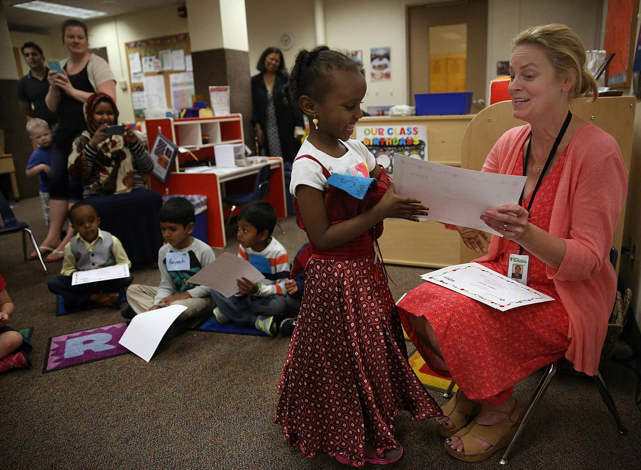 An enthusiastic Safaa Hassan, 5, received her diploma from teacher Annie Freeman during a graduation ceremony for preschoolers will be held at the Edina Family Center. ] JIM GEHRZ ï james.gehrz@startribune.com / Edina, MN / May 29, 2015 / 2:00 PM ñ BACKGROUND INFORMATION: Itís the last day of school at the Edina Public Schools, where a graduation ceremony for preschoolers will be held at the Edina Family Center.