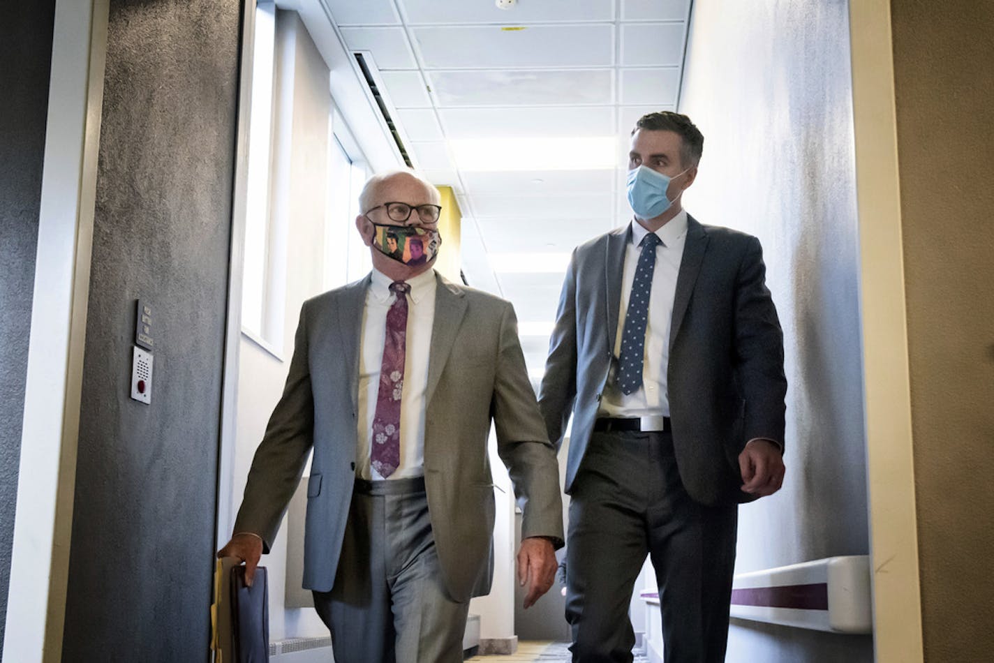 Former Minneapolis police officer Thomas Lane, right, walks out of the Hennepin County Public Safety Facility on Monday afternoon June 20, 2020, in Minneapolis with his attorney, Earl Gray, after a hearing. Lane is one of four former officers charged in the death of George Floyd. (Glen Stubbe/Star Tribune via AP)