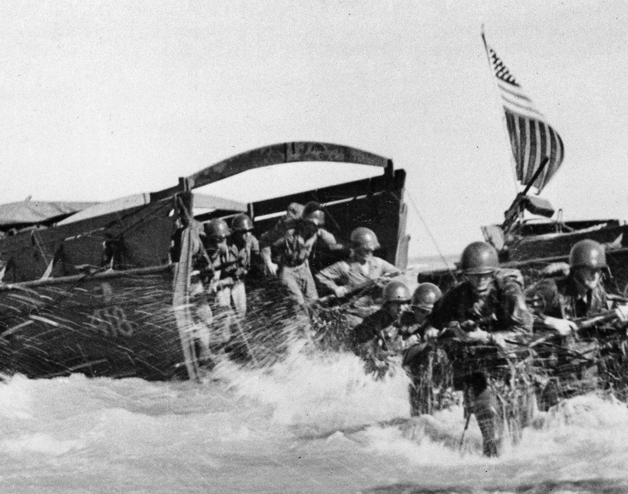 In this image provided by the U.S. Army Signal Corps, the first wave of U.S. Infantrymen leave their higgins boats and race through the surf for the beach during the invasion of Wakde Island, Dutch New Guinea, in 1944 during World War II. (AP Photo/U.S. Army Signal Corps, Kent Rocks) ORG XMIT: APHS039766