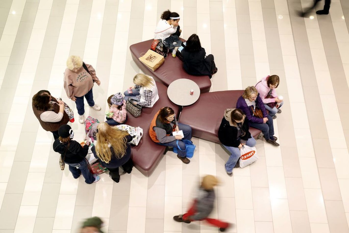 Shoppers rest on benches on Black Friday at Mall of America in Bloomington on Friday, November 28, 2014.