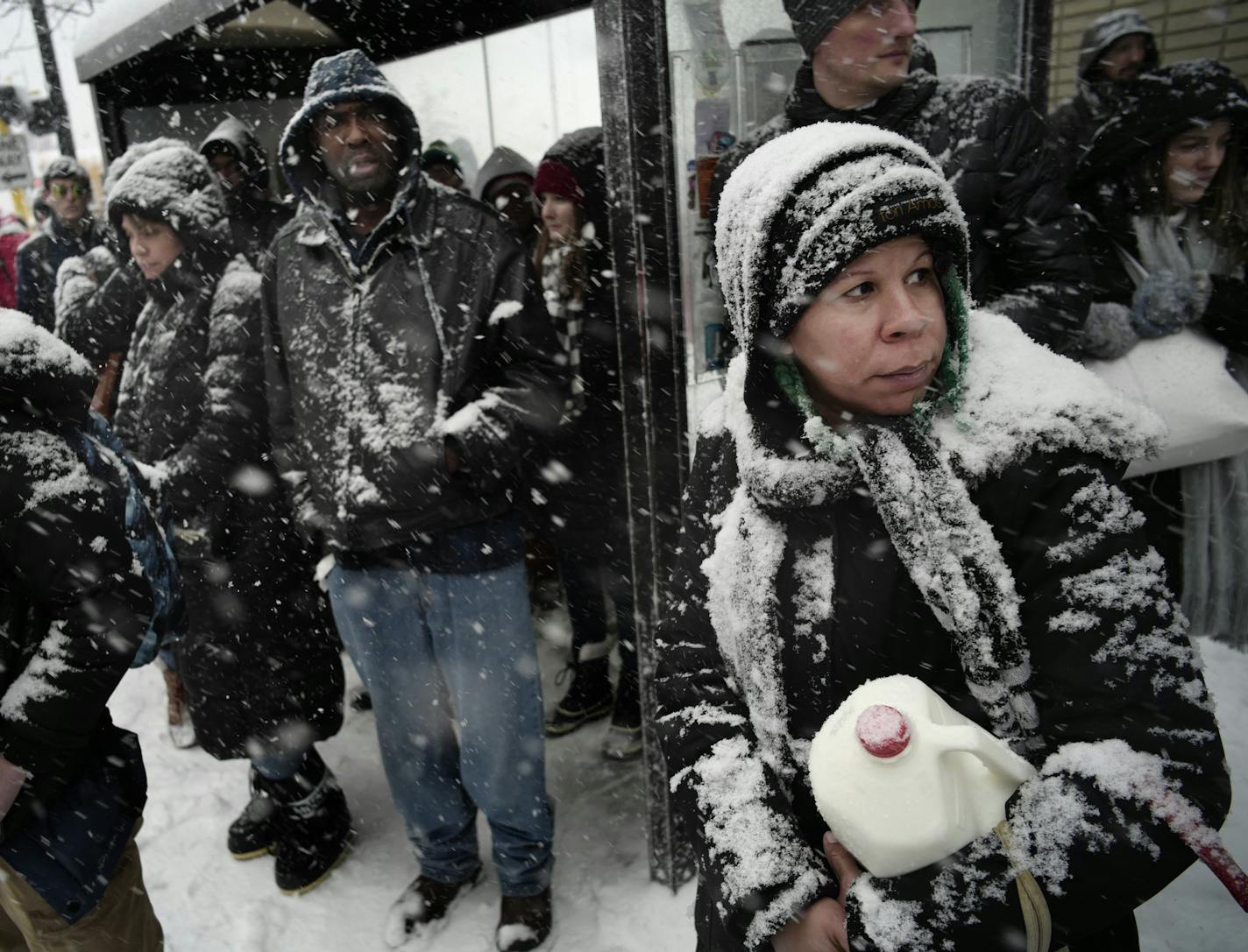 Commuters downtown waited for the bus early in the afternoon in the hope of beating the bad weather including Timmy Johnson, far right, who picked up some milk at Target. She is grateful to have the next two days off.] Lots of snow expected early Monday, no doubt snarling commutes and causing other havoc.Richard Tsong-Taatarii&#xef;rtsong-taatarii@startribune.com