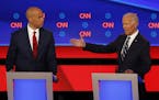 Sen. Cory Booker, D-N.J., listens to former Vice President Joe Biden during the second of two Democratic presidential primary debates hosted by CNN We