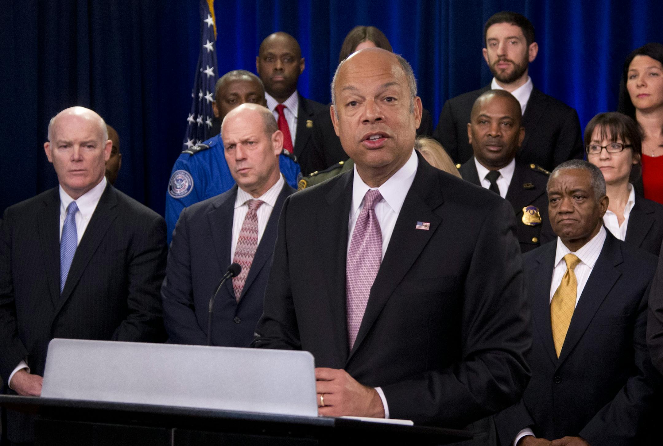 Homeland Security Secretary Jeh Johnson, joined by the department employees, speaks during a news conference in Washington, Monday, Feb. 23, 2015, to discuss the need for Congress to pass a full-year appropriations bill and how failing to fund DHS impacts our personnel and their families. Standing second from left, is U.S. Secret Service Director Joseph Clancy, and U. S. Customs and Border Protection Commissioner Gil Kerlikowske, right. (AP Photo/Manuel Balce Ceneta)