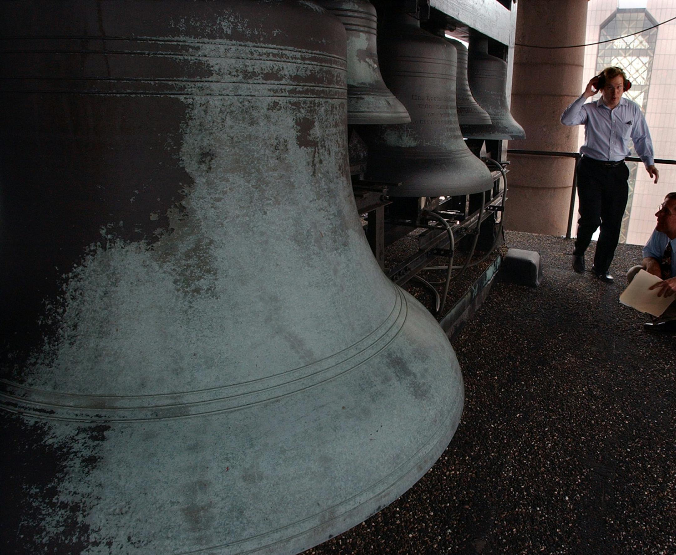 Joey McLeister/Star Tribune Minneapolis,Mn.,Fri.,July 2, 2004--Tony Hill, chair of the City Hall Carillon Committee, wears a headset to protect his ears as he walks among the big bells at the top of Minneapolis City Hall.
GENERAL INFORMATION: Tony Hill, Chair of the City Hall Carillon Committee, gives a tour of the bells at Minneapolis City Hall.