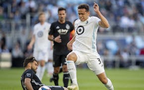 Graham Zusi (8) Sporting Kansas City and Hassani Dotson (31) of Minnesota United FC fought for the ball in the first half.