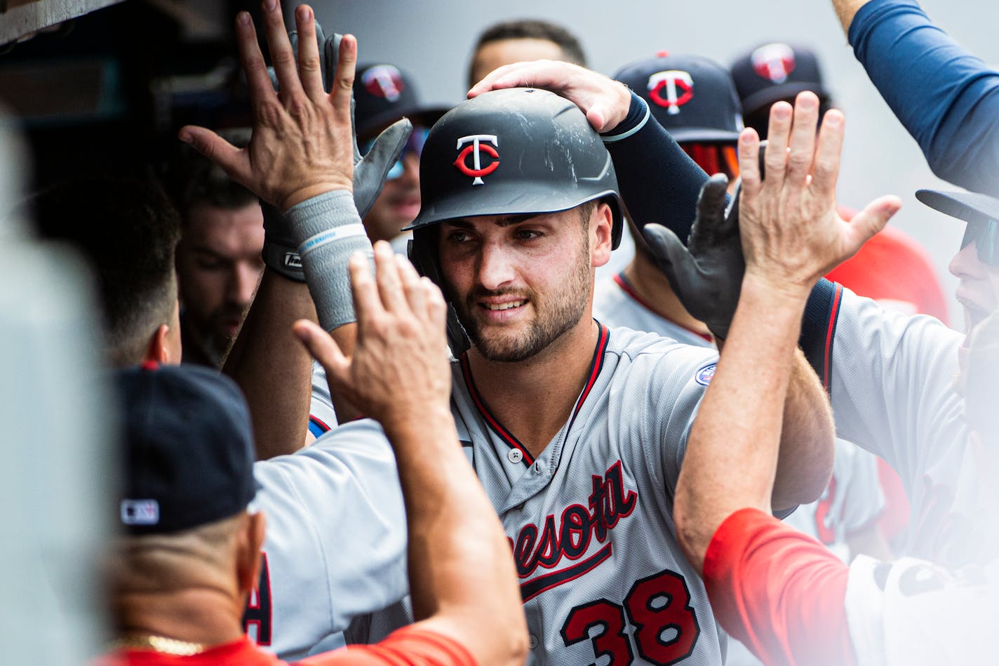 Minnesota Twins Matt Wallner (38) is congratulated by his teammates after hitting a solo home run off Cleveland Guardians starting pitcher Shane Bieber during the eighth inning in the first game of a baseball doubleheader in Cleveland, Saturday, Sept. 17, 2022. Today is Wallner's Major League debut. (AP Photo/Phil Long)