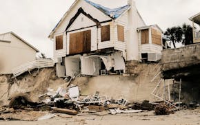 Homes are left destroyed after storm surge from Hurricane Nicole collapsed the sea wall on Wilbur Beach, in Wilbur-By-The-Sea, Fla. on Thursday, Nov.