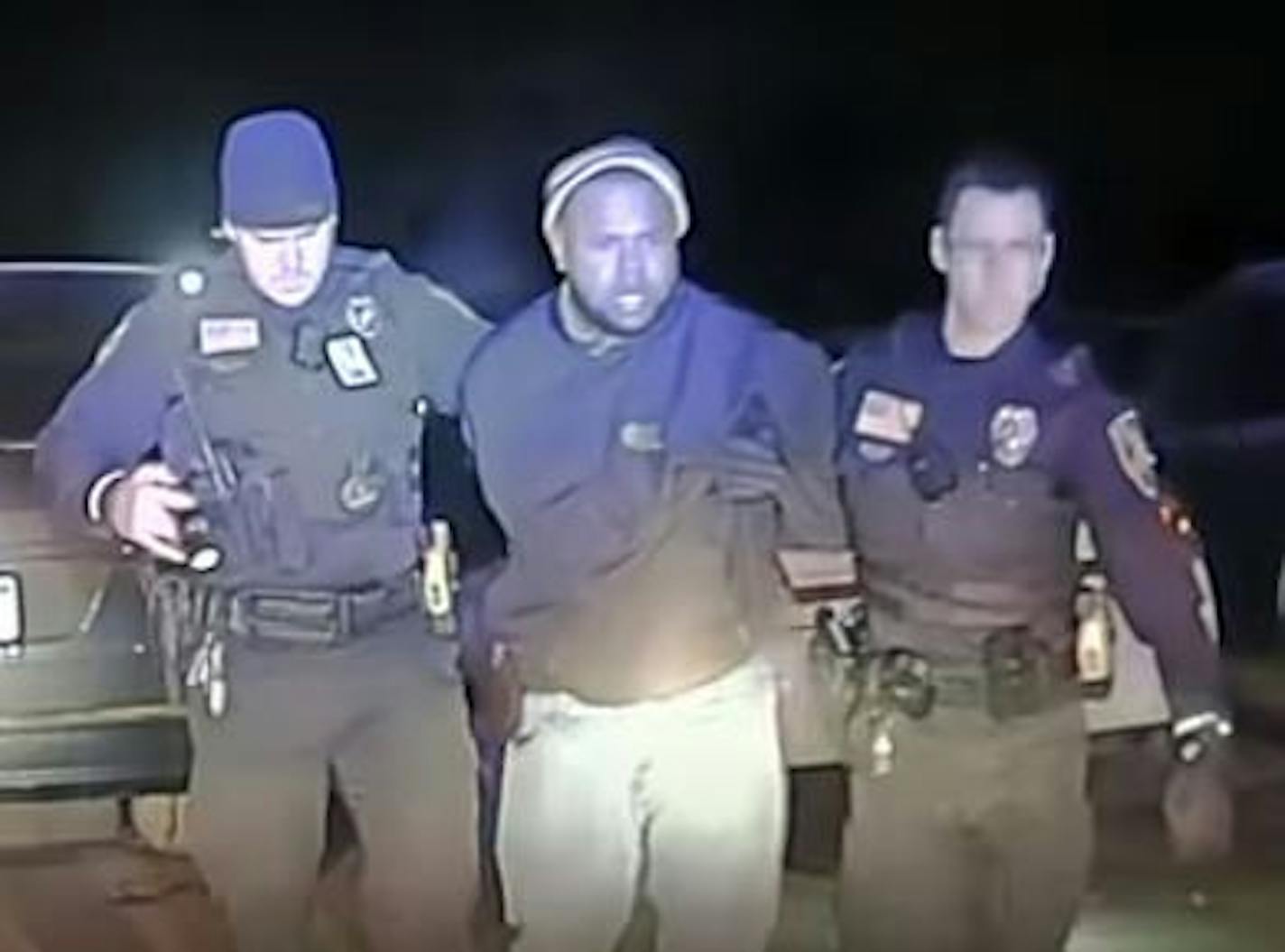 Squad car video shows officers Mark Riley, left, and Micah Mesman escorting Kelvin Rodriguez from an auto dealership parking lot in January. Mesman is not a defendant in the lawsuit filed on the behalf of Rodriguez. Credit: Provided by the ACLU of Minnesota