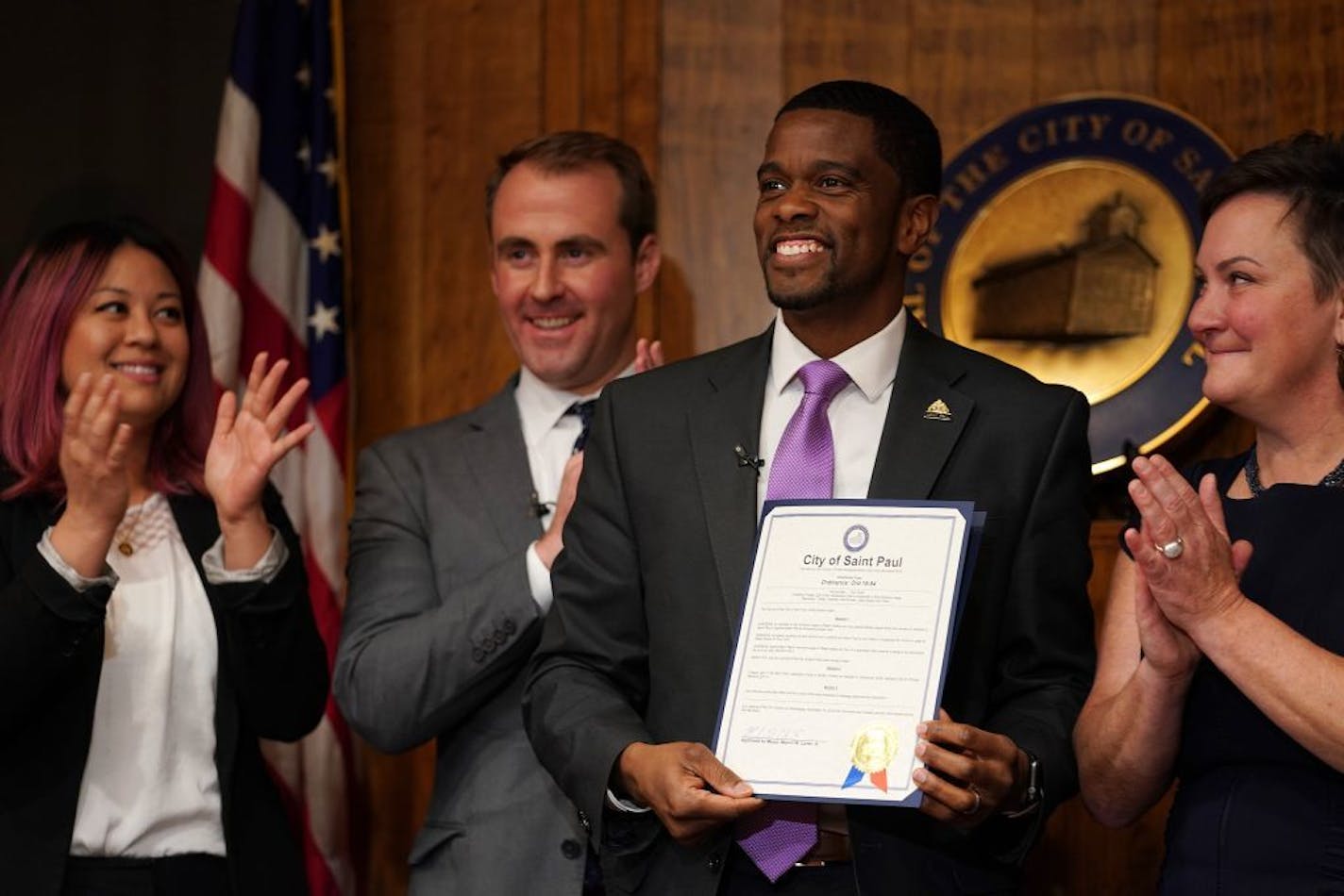 St. Paul Mayor Melvin Carter smiled after signing the $15 minimum wage ordinance.