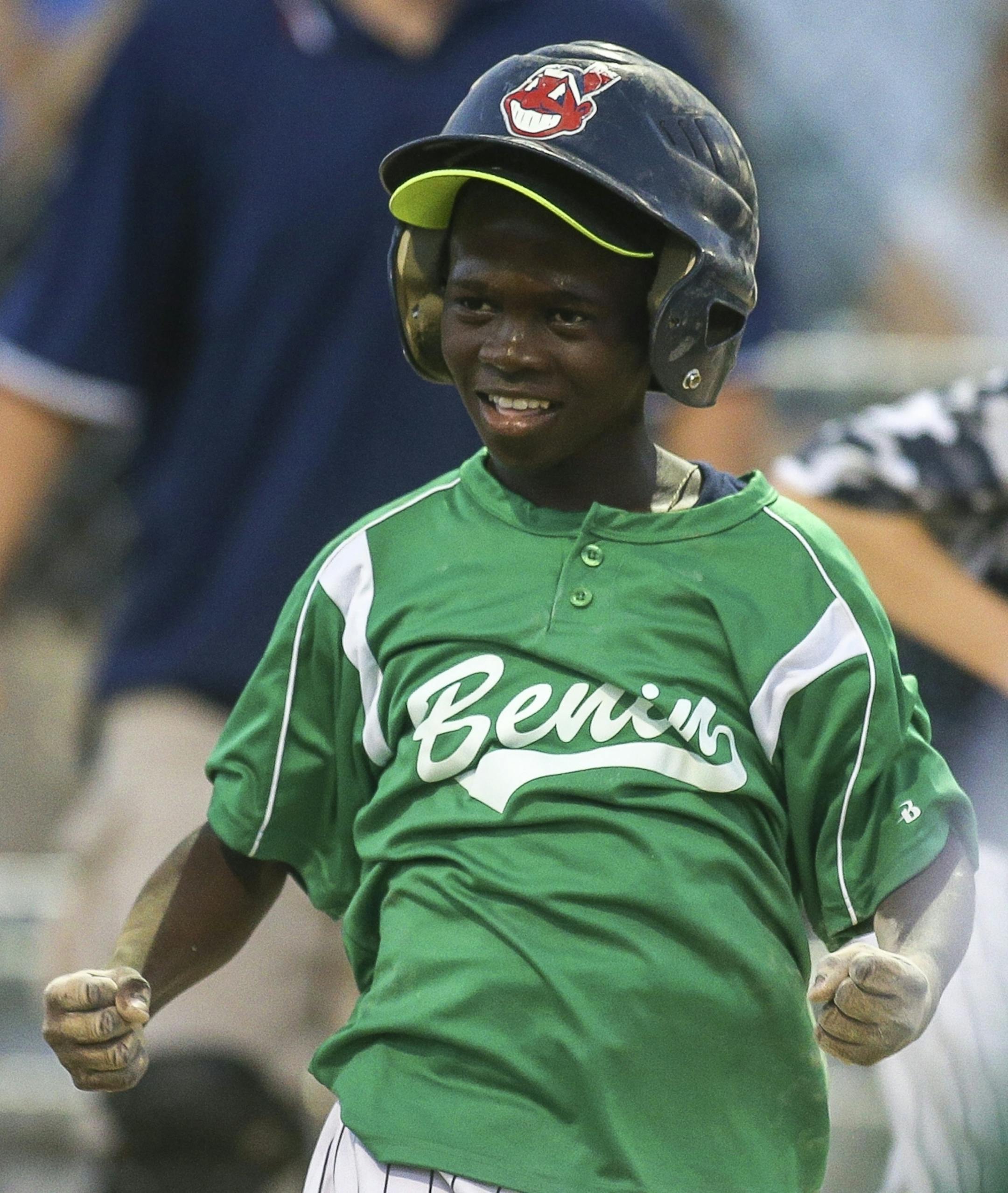 Bill Sagbo celebrates after successfully sliding into home plate during Benin's scrimmage against the Robbinsdale 10-year-old all-star team at Lakeview Terrace Park on Tuesday, August 2, 2016 in Robbinsdale.