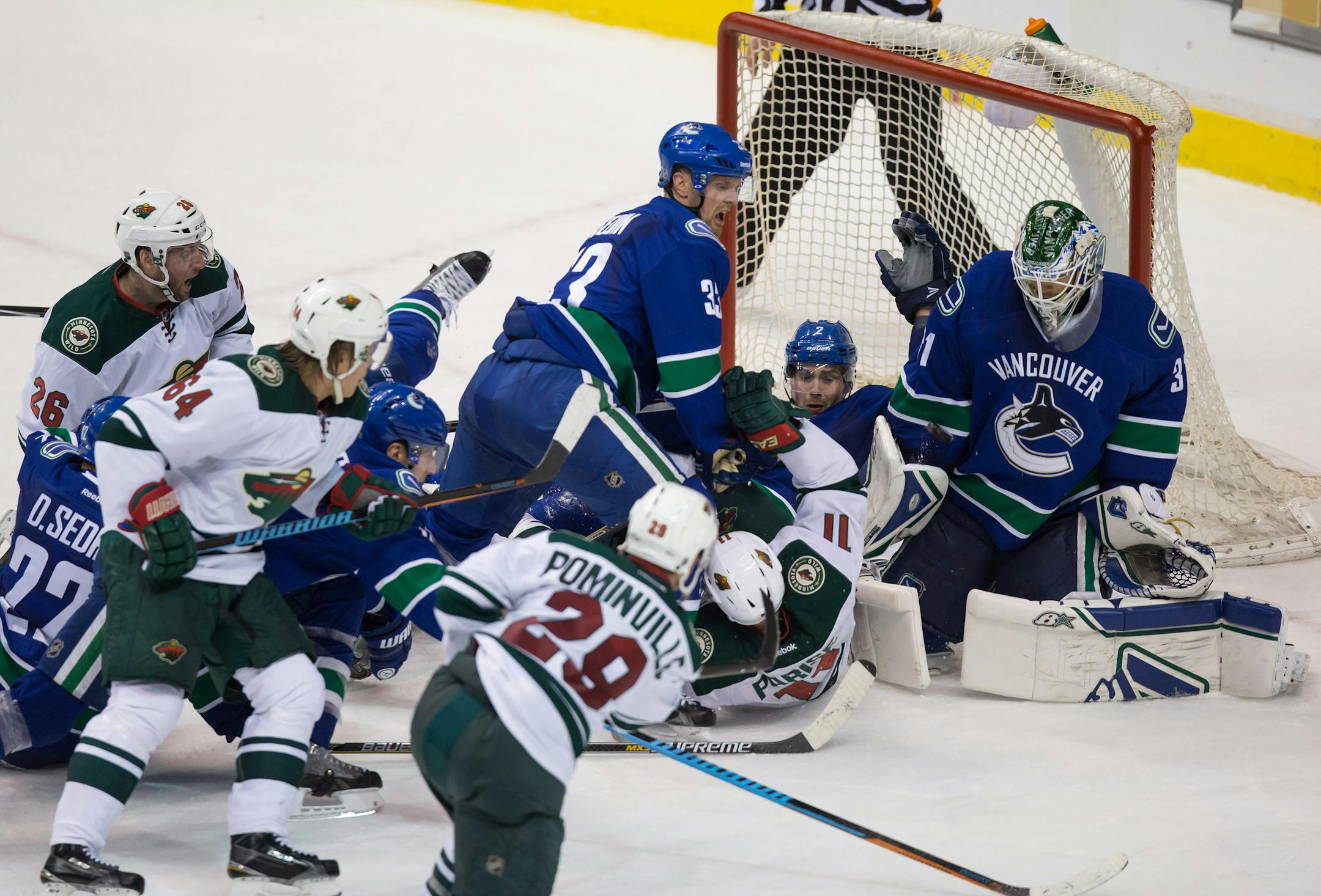 Vancouver goalie Eddie Lack made a save on the Wild's Jason Pominville amid a flurry in front of the net late in the third period Monday night.