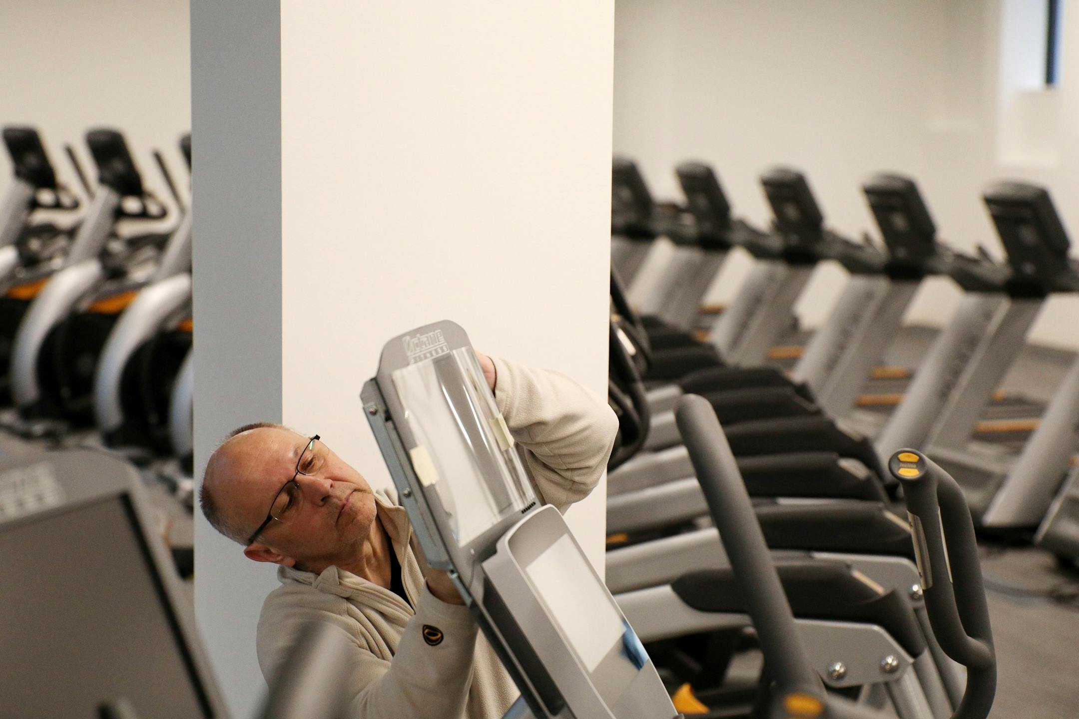 Mark Brue with Octane Fitness installed a screen on a piece of exercise equipment.