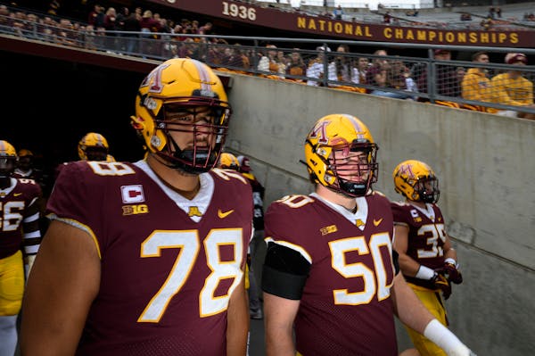 Gophers offensive linemen Daniel Faalele (78) and JJ Guedet (50)