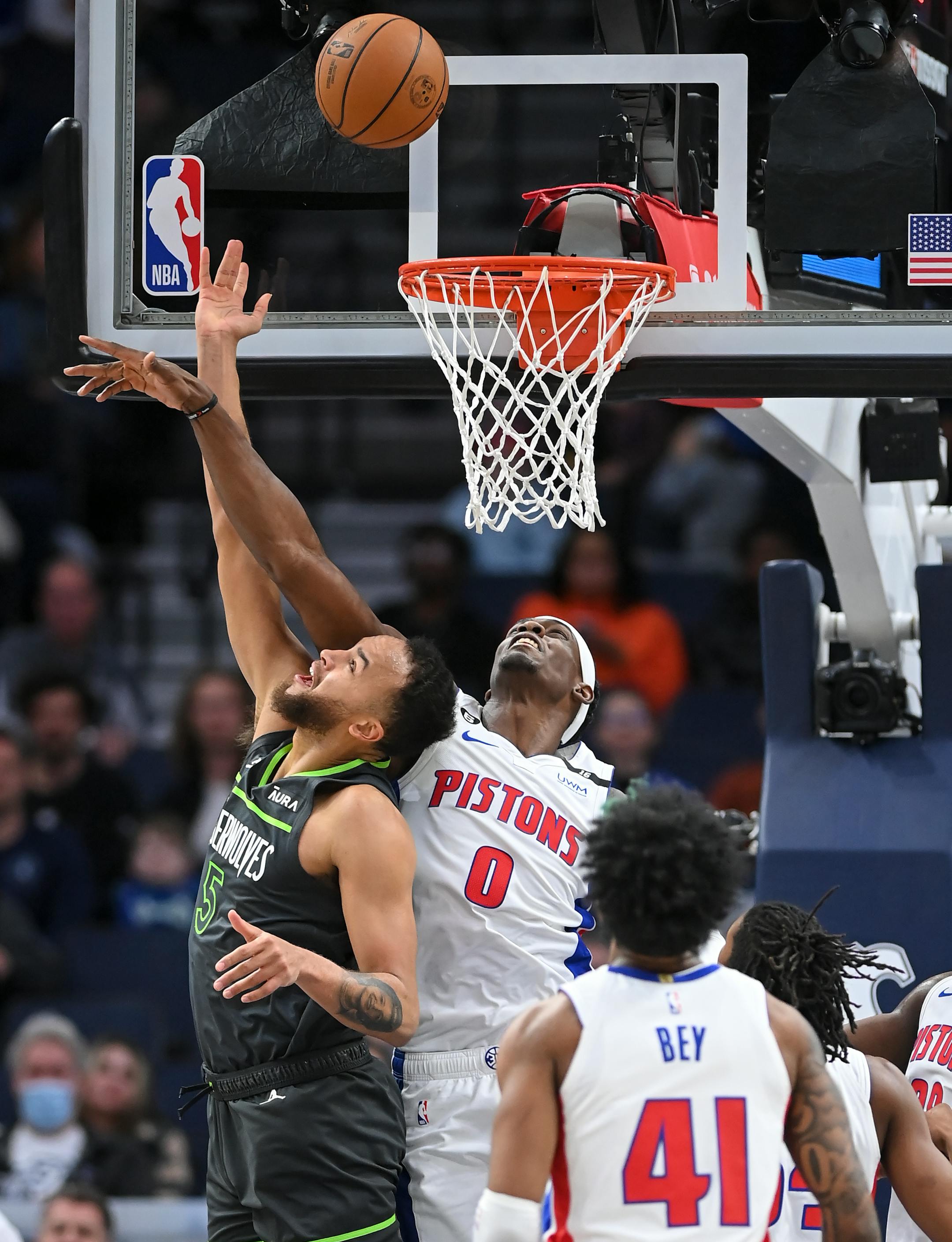 Detroit Pistons center Jalen Duren (0) fouls Minnesota Timberwolves forward Kyle Anderson (5) during a basket, sending Anderson to the line for two free throws during the first half.