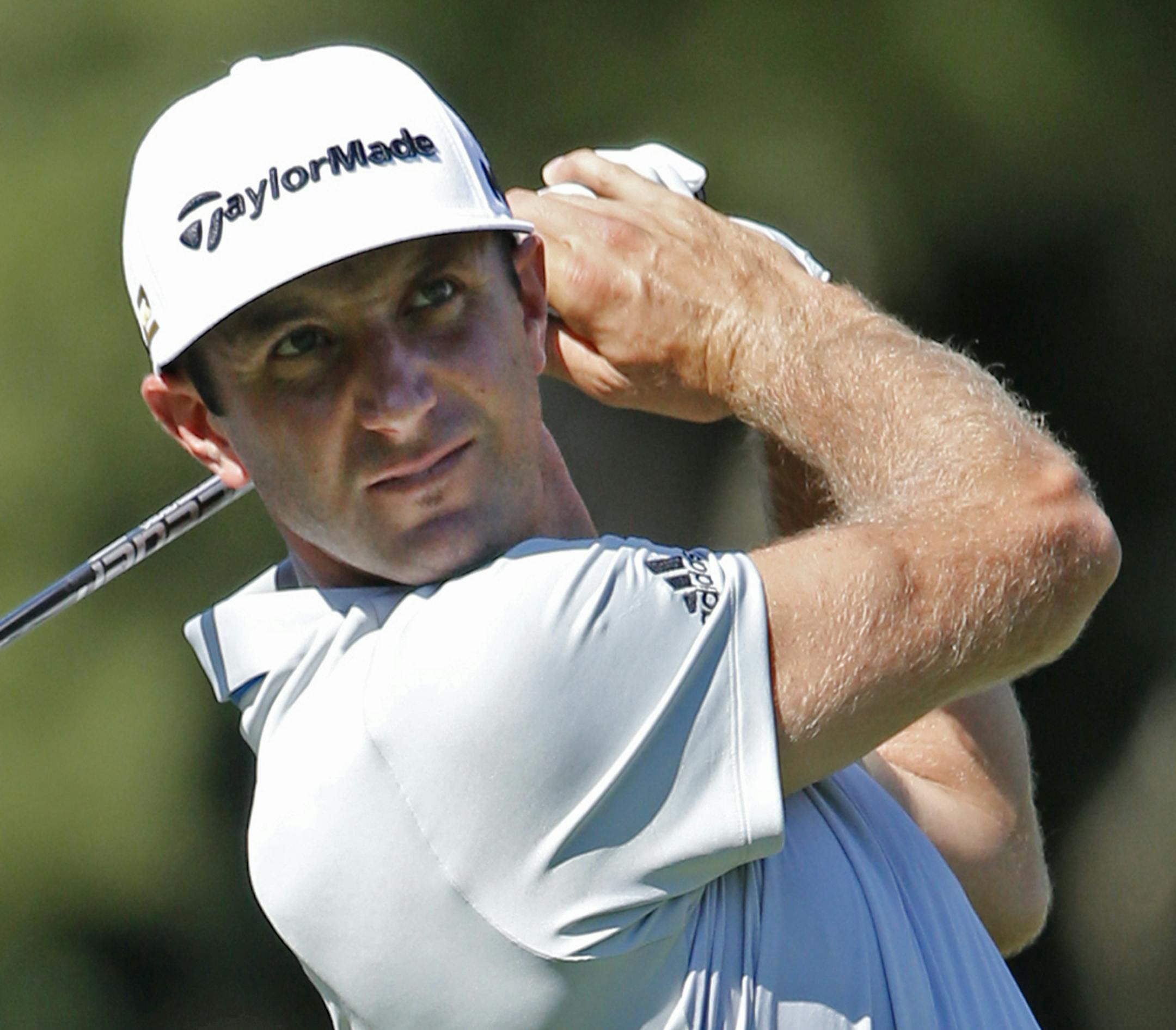Dustin Johnson watches his tee shot on the 17th hole during a practice round for the PGA Championship golf tournament at Baltusrol Golf Club in Springfield, N.J., Wednesday, July 27, 2016. (AP Photo/Mike Groll)